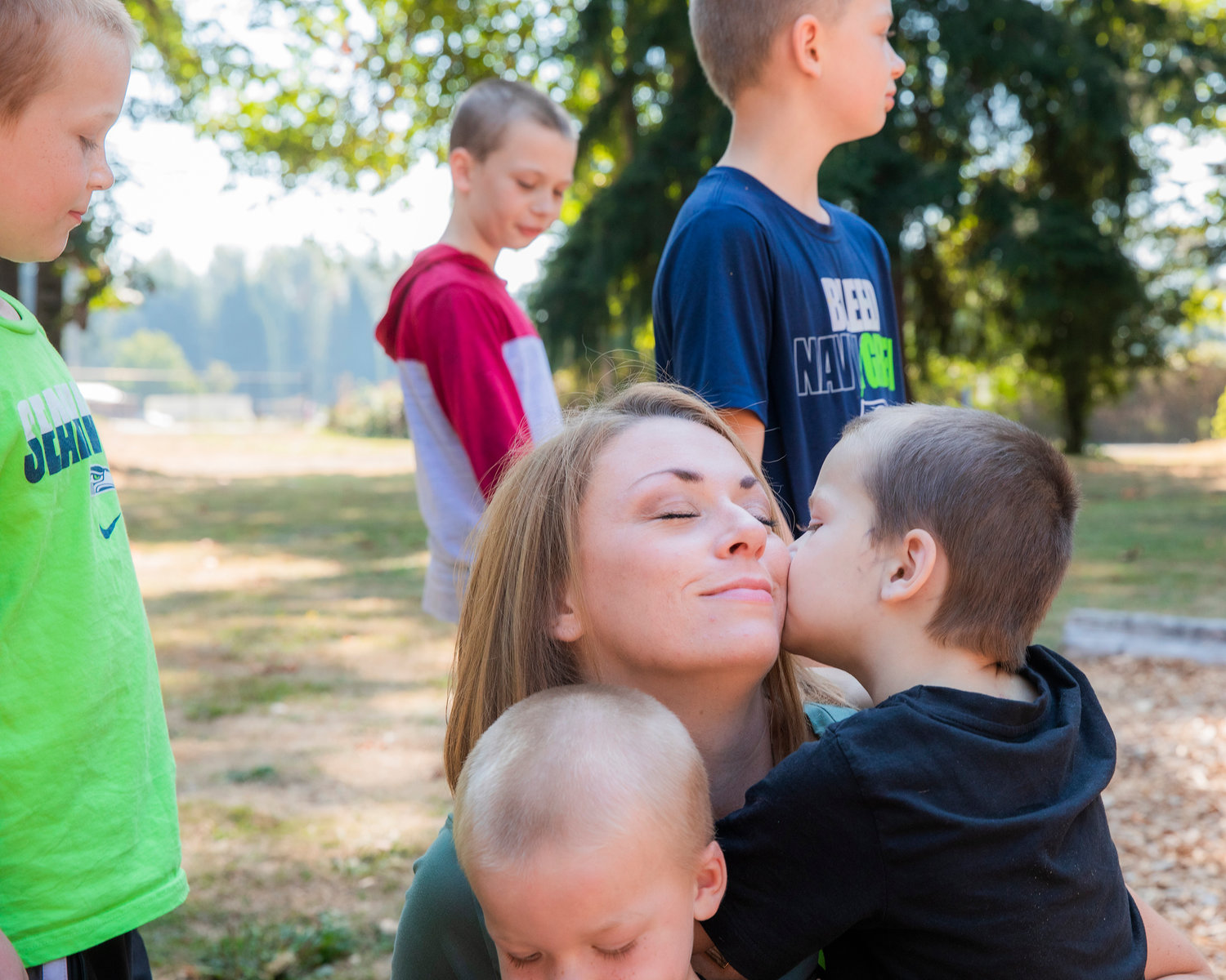 Rena Kreis receives a kiss from Titus Sickles, 4, Tuesday afternoon at Kemp Olson Memorial Park in Toledo.