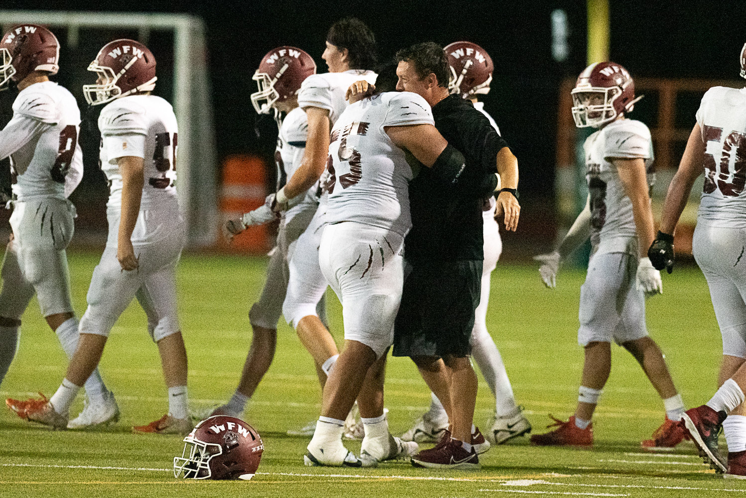 W.F. West coach Dan Hill hugs senior lineman Daniel Matagi after the Bearcats wrapped up their 28-7 win over Tumwater on Sept. 30 at Tumwater District Stadium. The Bearcats hadn't beaten the Thunderbirds since 2009.