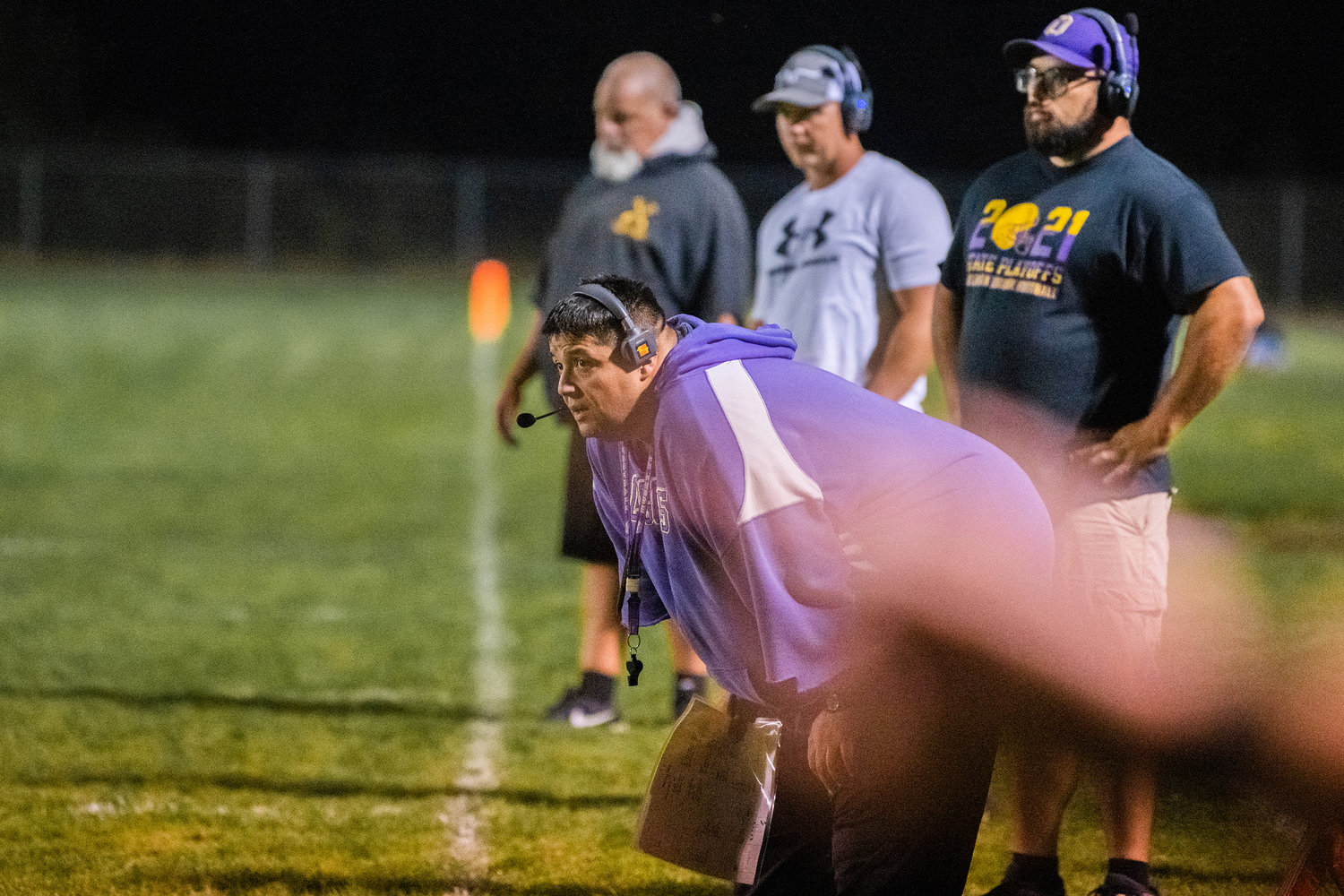 Onalaska coaches look to the field during a Friday night game in Toledo.