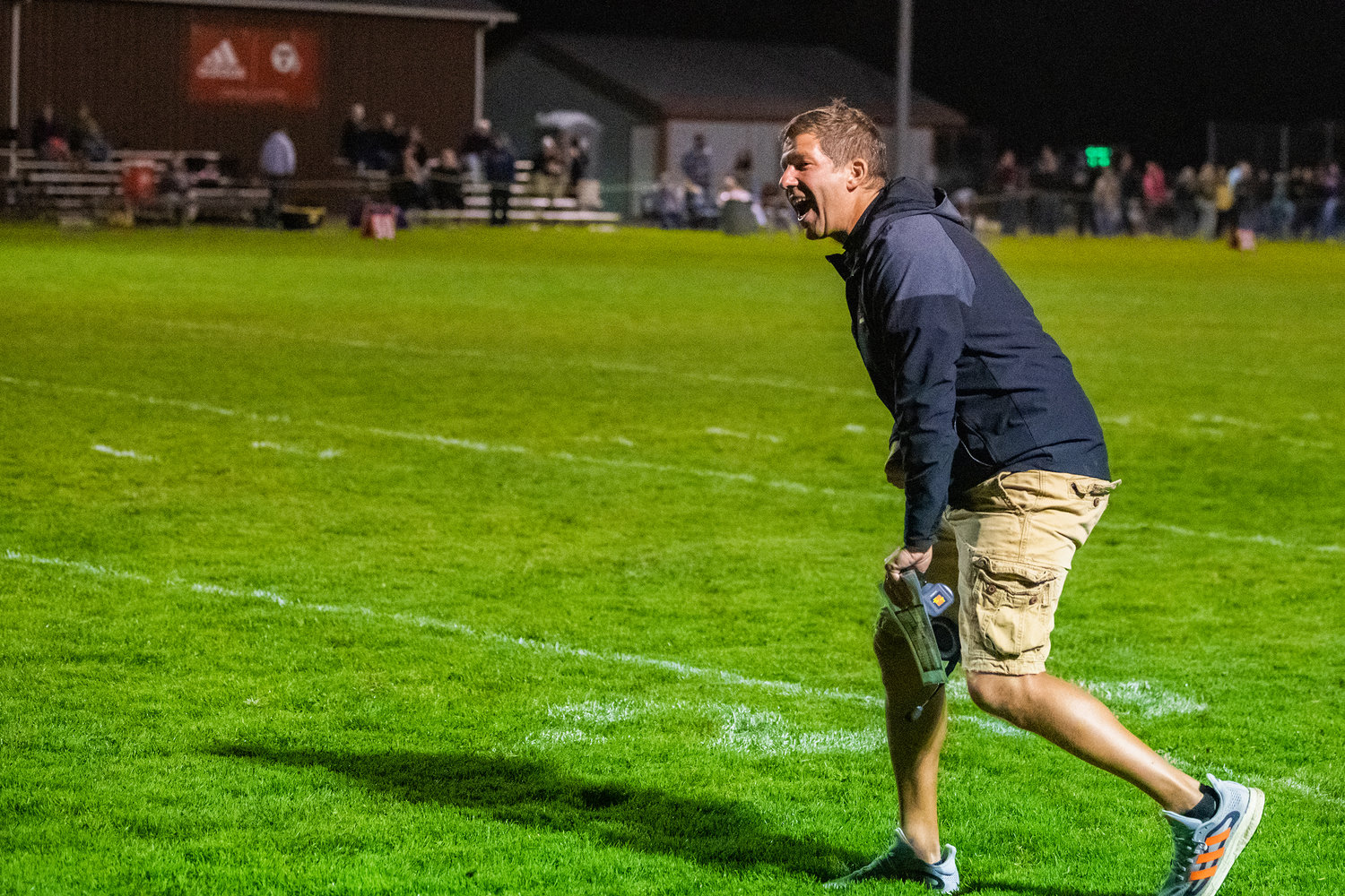 Toledo Head Coach Mike Christensen smiles and runs onto the field as the Riverhawks score Friday night against Onalaska.