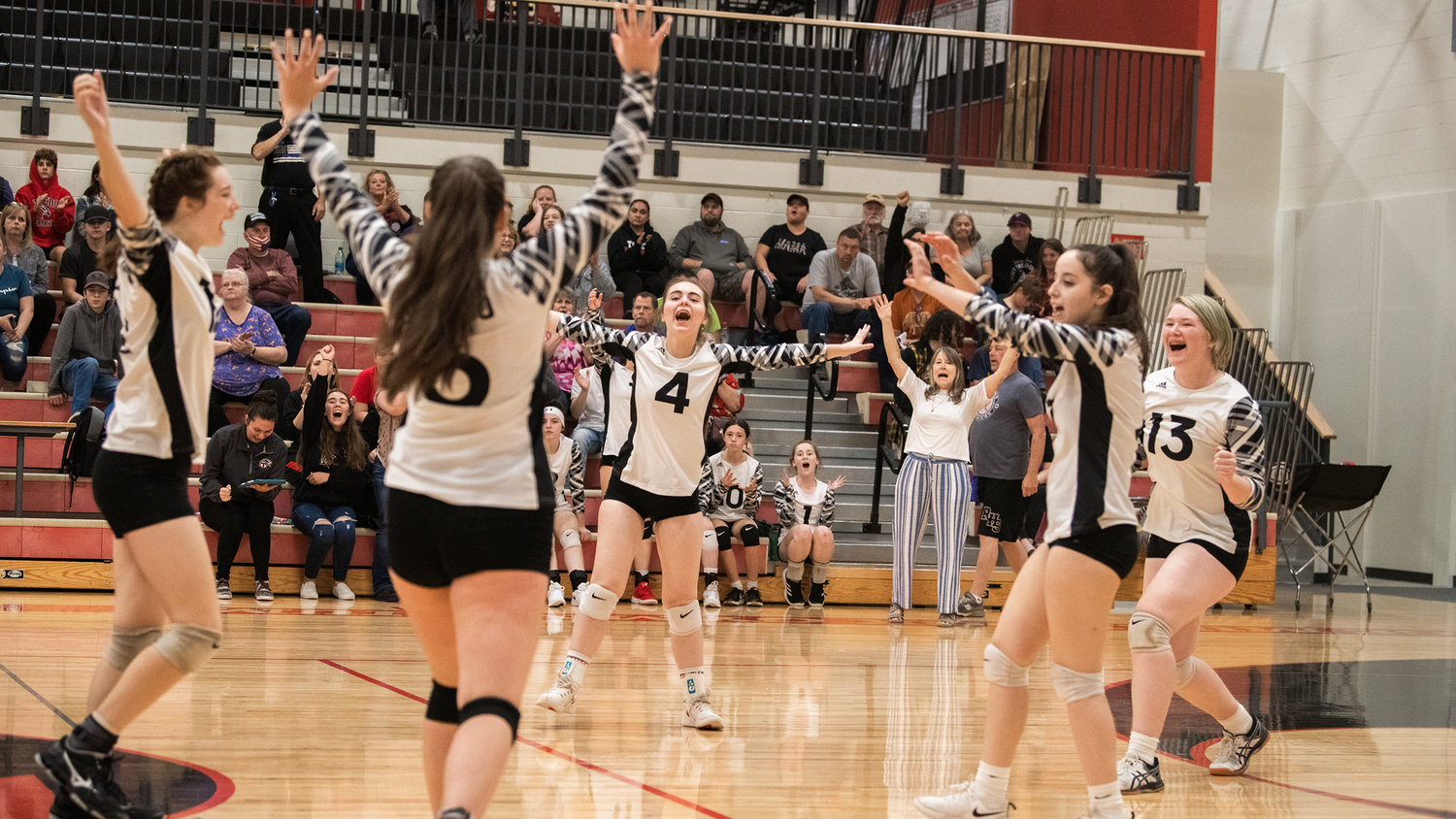 Riverhawks celebrate a point during a game against Rainier on Tuesday.