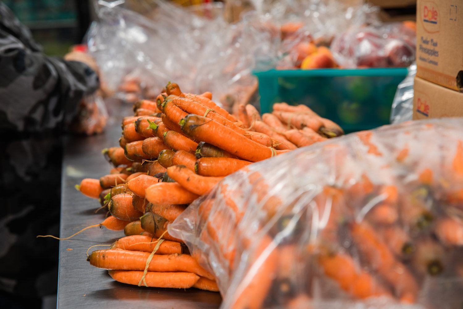 Carrots are organized into bags for meals by volunteers at Tenino Food Bank Plus Monday morning.
