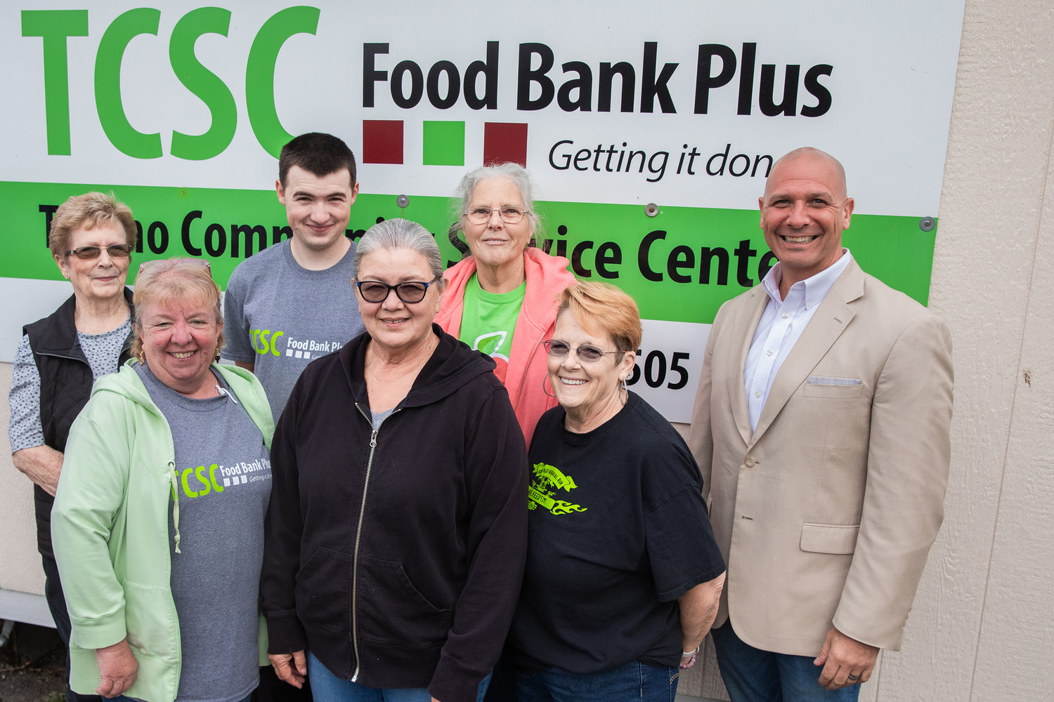 State Rep. Peter Abbarno smiles for a photo with employees and volunteers at the Tenino Community Service Center Food Bank Monday morning during a tour of the facility.