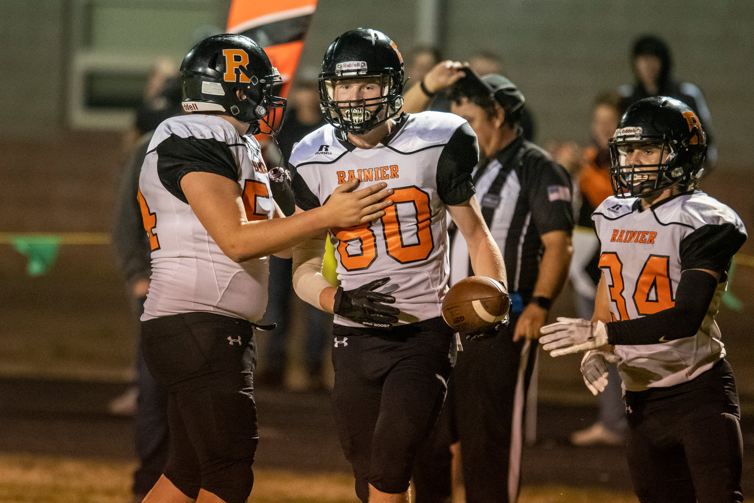 Rainier's John Kenney (80) gets congratulated after hauling in a touchdown reception in the second quarter against Raymond-South Bend on Oct. 7 in Raymond.