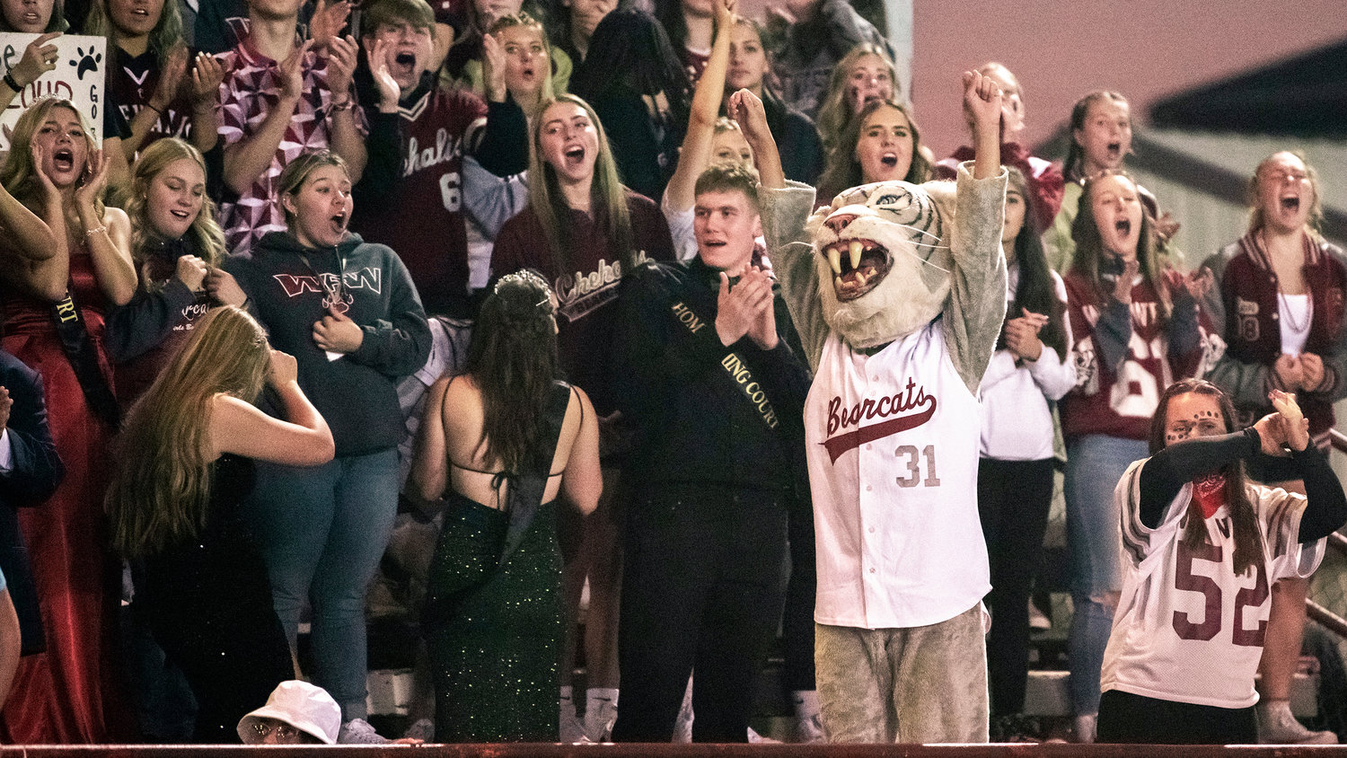 W.F. West fans cheer alongside the Bearcat mascot during a game Friday night in Chehalis.
