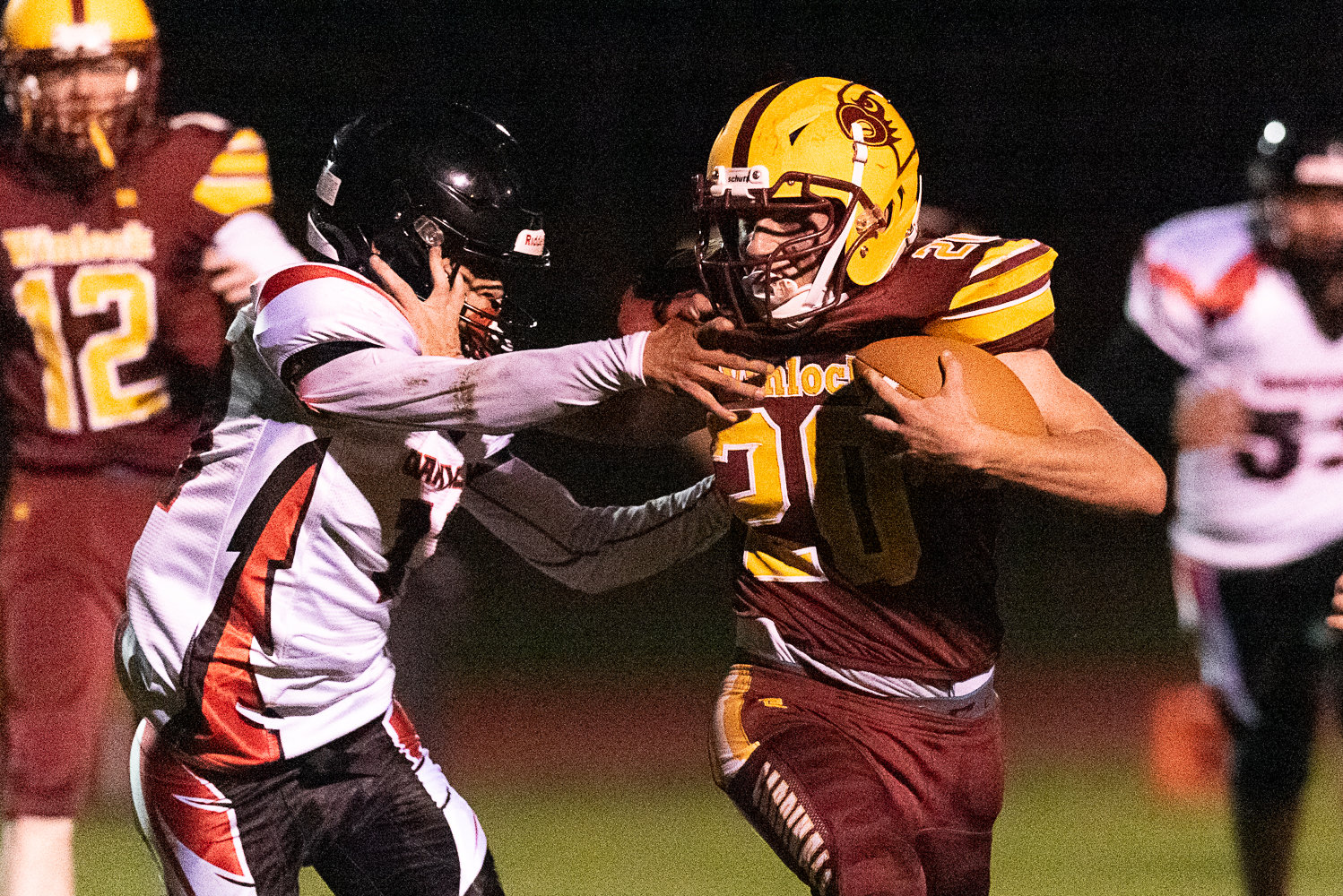 Winlock's Kaiden Perkins stiff-arms a defender during the Cardinals' 36-28 win over Oakville on Oct. 7.
