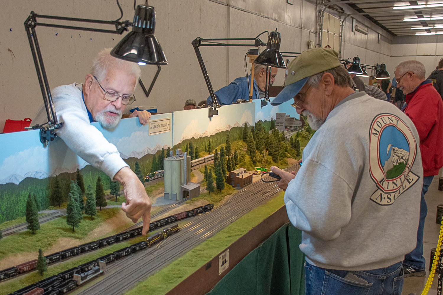Dennis Reeve, right, and Greg Okrasinski, left, troubleshoot an electrical track issue on the Mount Rainier display they both helped create. Okrasinski claimed that in this display there was over a mile's worth of model train tracks laid out. The Lewis County Model Railroad Club hosted a swap meet and show Saturday and Sunday in the Blue Pavilion at the Southwest Washington Fairgrounds.