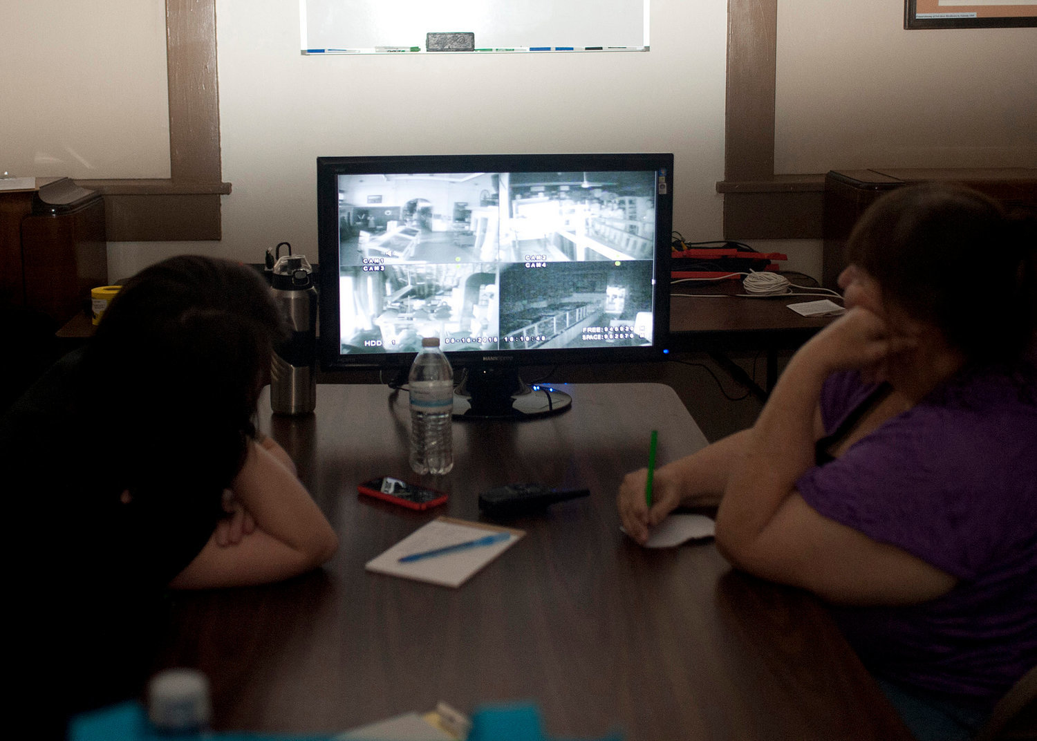 Members of South Sound Paranormal Research watch live video feed from infrared cameras placed in strategic locations during a paranormal investigation at the Lewis County Historical Museum in 2015.