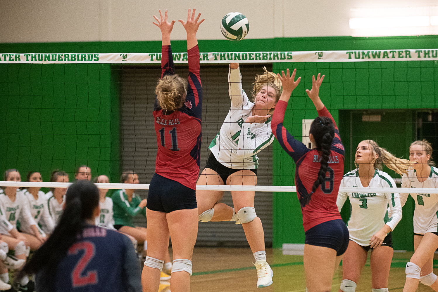 Maddie Hurley gets a spike past the Black Hills block during Tumwaters' win over the Wolves on Oct. 11.