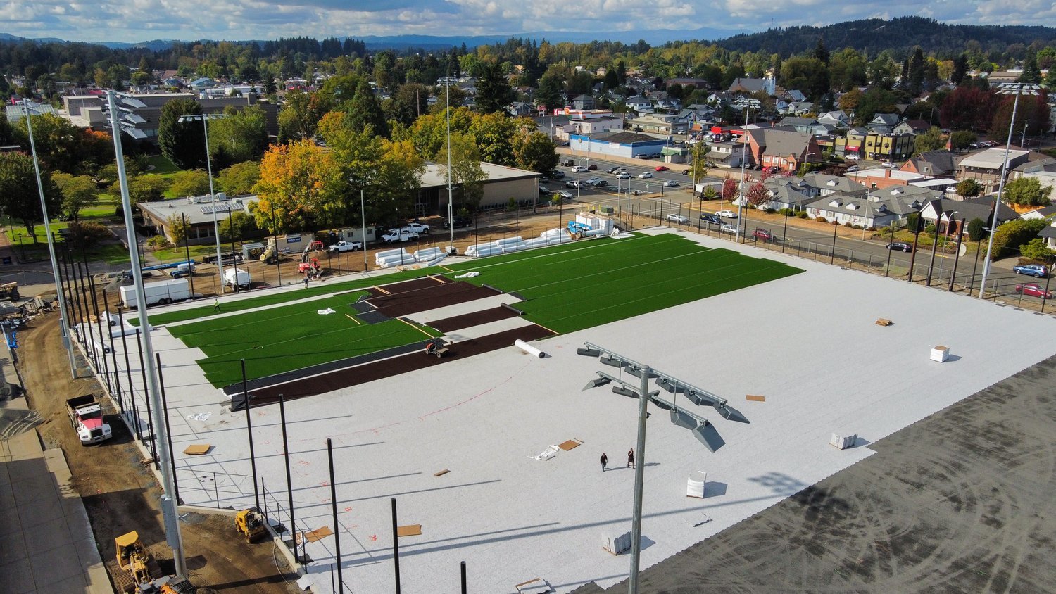 Turf is rolled out onto a multisport athletic field at the Centralia College Campus last month.