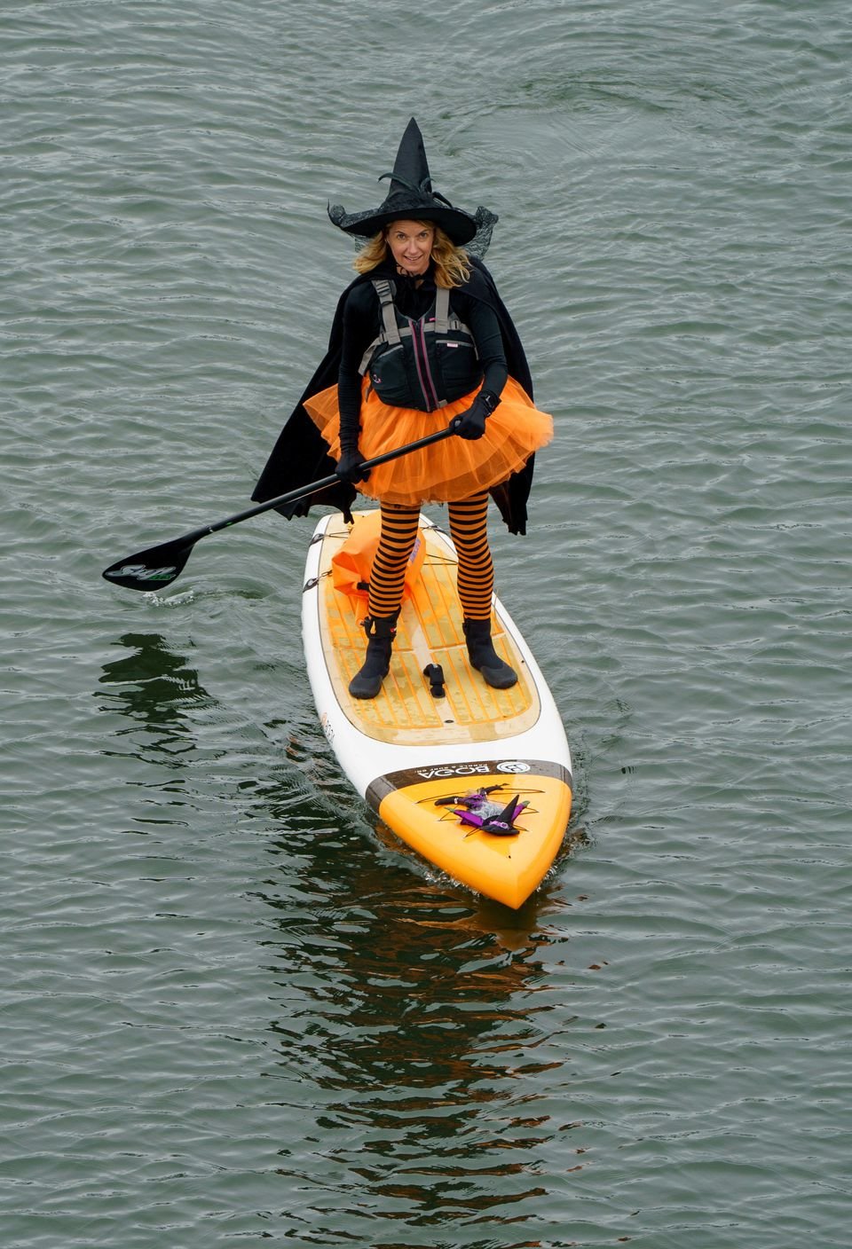 Hundreds of witches clad in black, along with some warlocks and sorcerers, took to the Willamette River Saturday, Oct. 29, 2022, wielding paddles instead of broomsticks, and conjured hocus pocus for the fifth annual Portland Stand Up Paddleboard Witches on the Willamette, also known as SUP WOW.