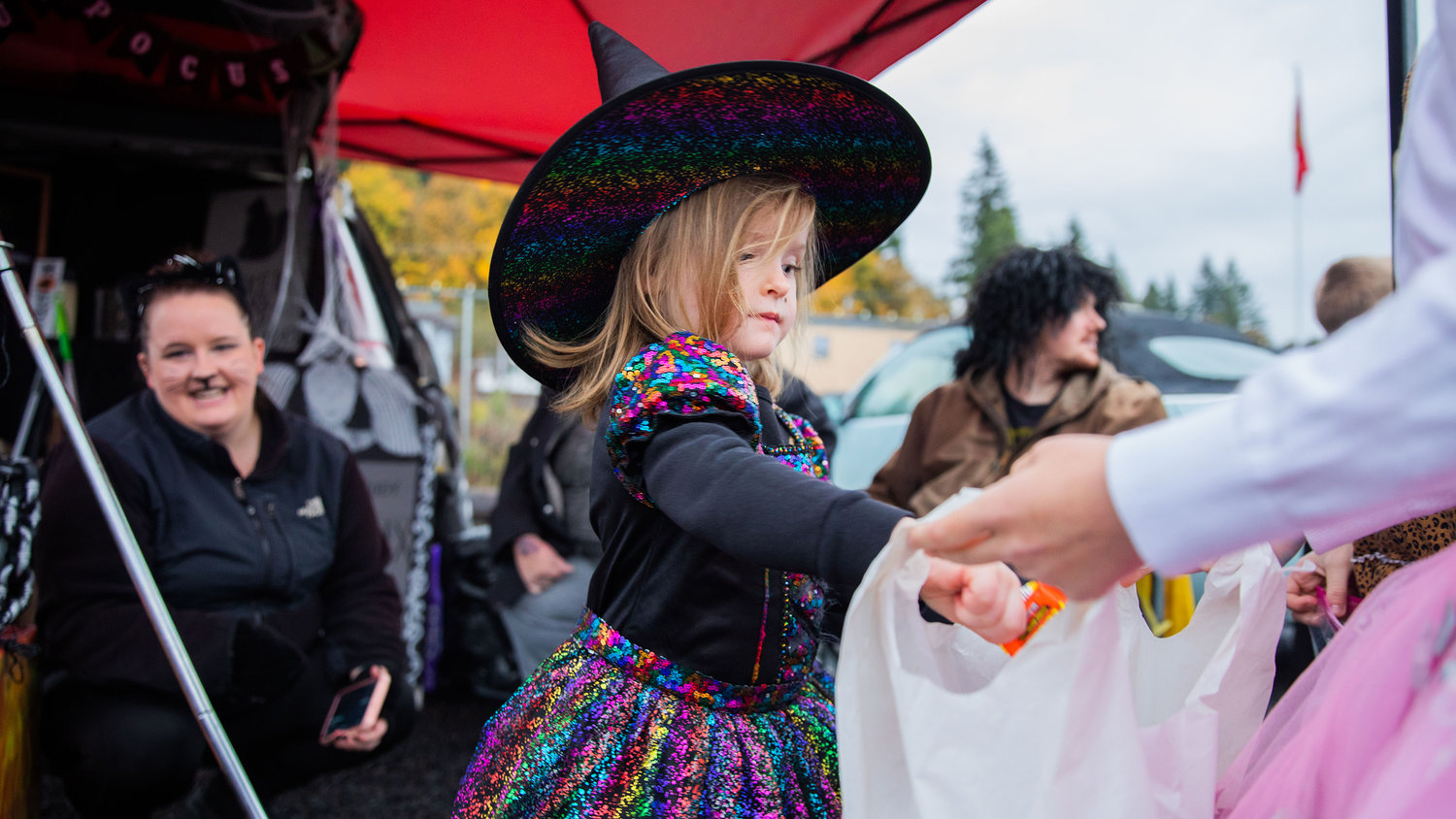 Kinzlee Banker, 4, of Winlock, hands out candy to trick-or-treaters during Egg-O-Lantern festivities on Halloween.