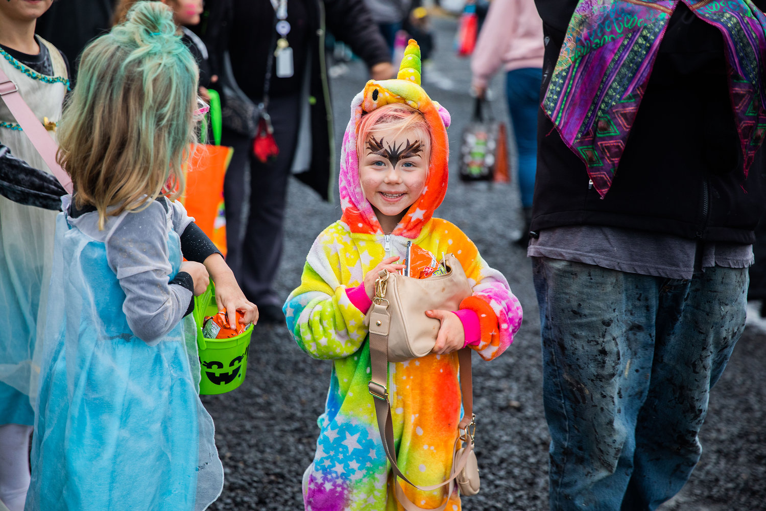 Zaysha Foley, 4, of Winlock smiles while holding a bag full of candy during Egg-O-Lantern festivities on Halloween.