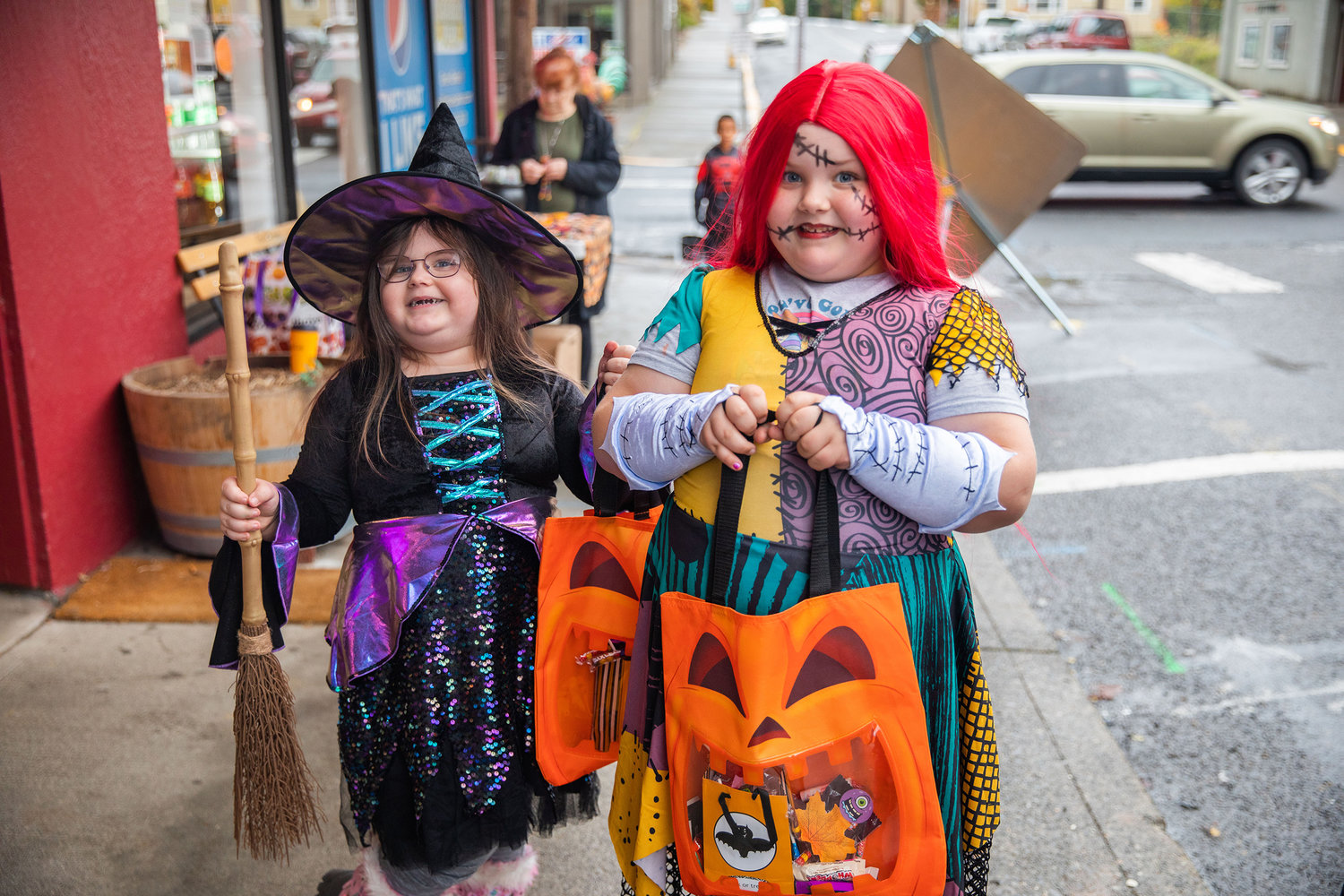 Hanna ,4, and Jade Neyland, 6, smile and pose for a photo while in costume in downtown Winlock on Halloween.