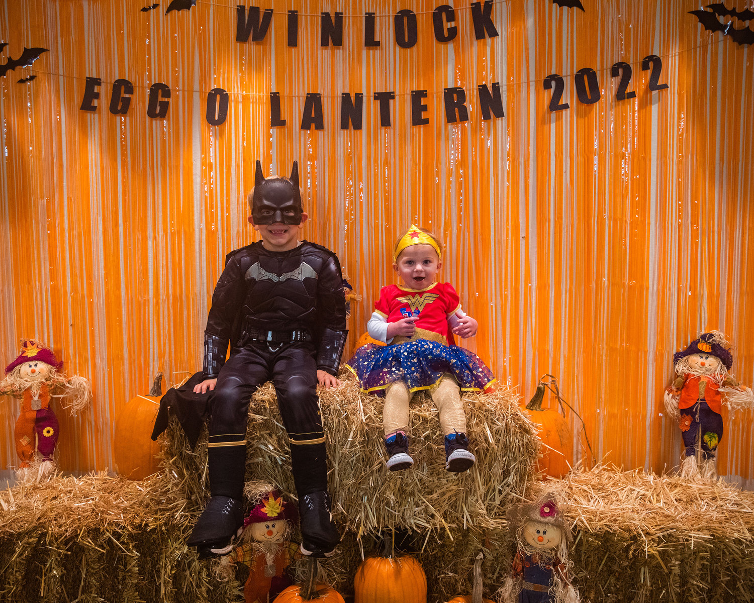Rowdy, left, and Logan Prosser, right, smile for a photo inside the Winlock Community Building during Egg-O-Lantern festivities on Halloween.