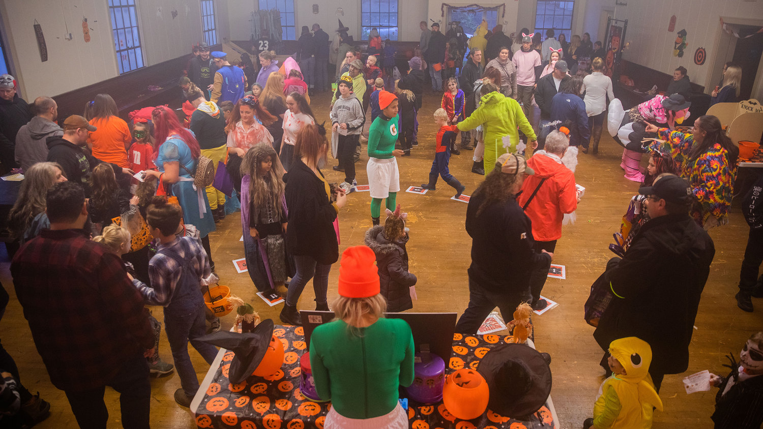 Visitors dressed in costume participate in a cake walk at the Winlock Community Building during Egg-O-Lantern festivities on Halloween.