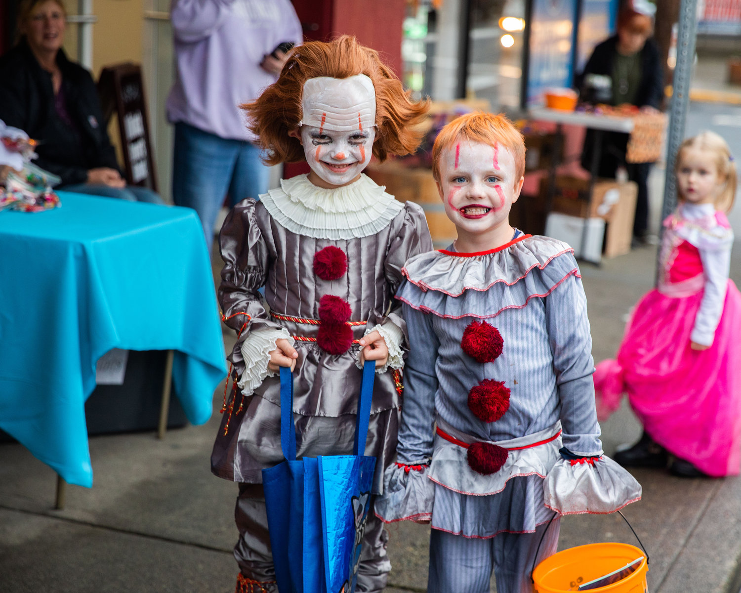 Riley Morton and Garrett Small smile for a photo in matching Pennywise costumes in downtown Winlock on Halloween.