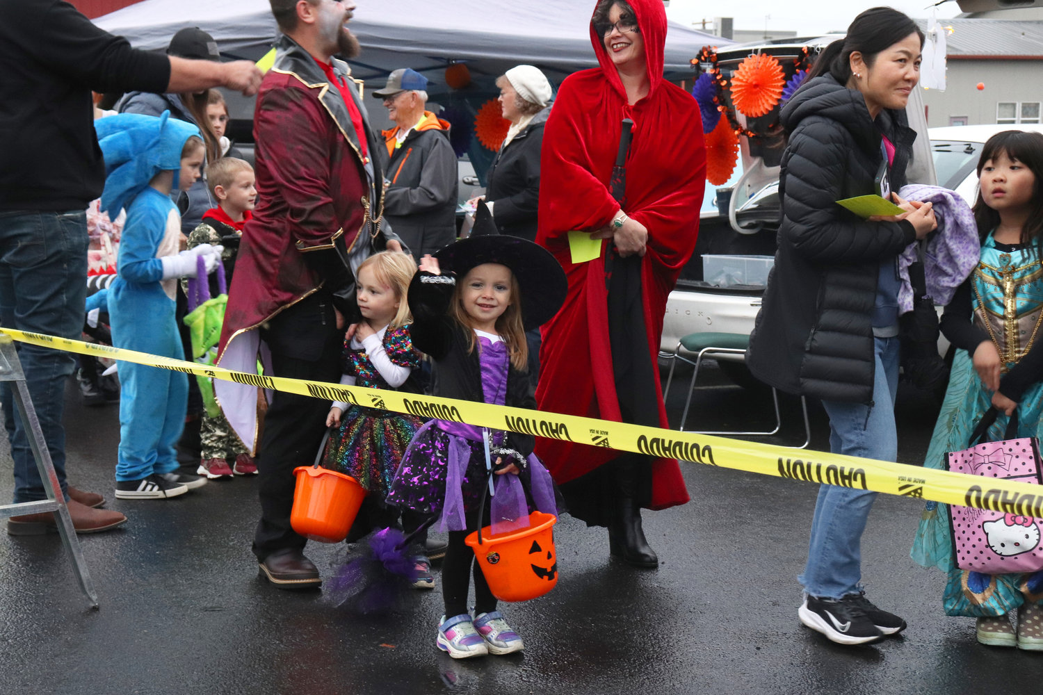 Adelaide, who turns 5 next week, waves to the camera while in line at Napavine Assembly of God Church’s trunk or treat event on Monday.