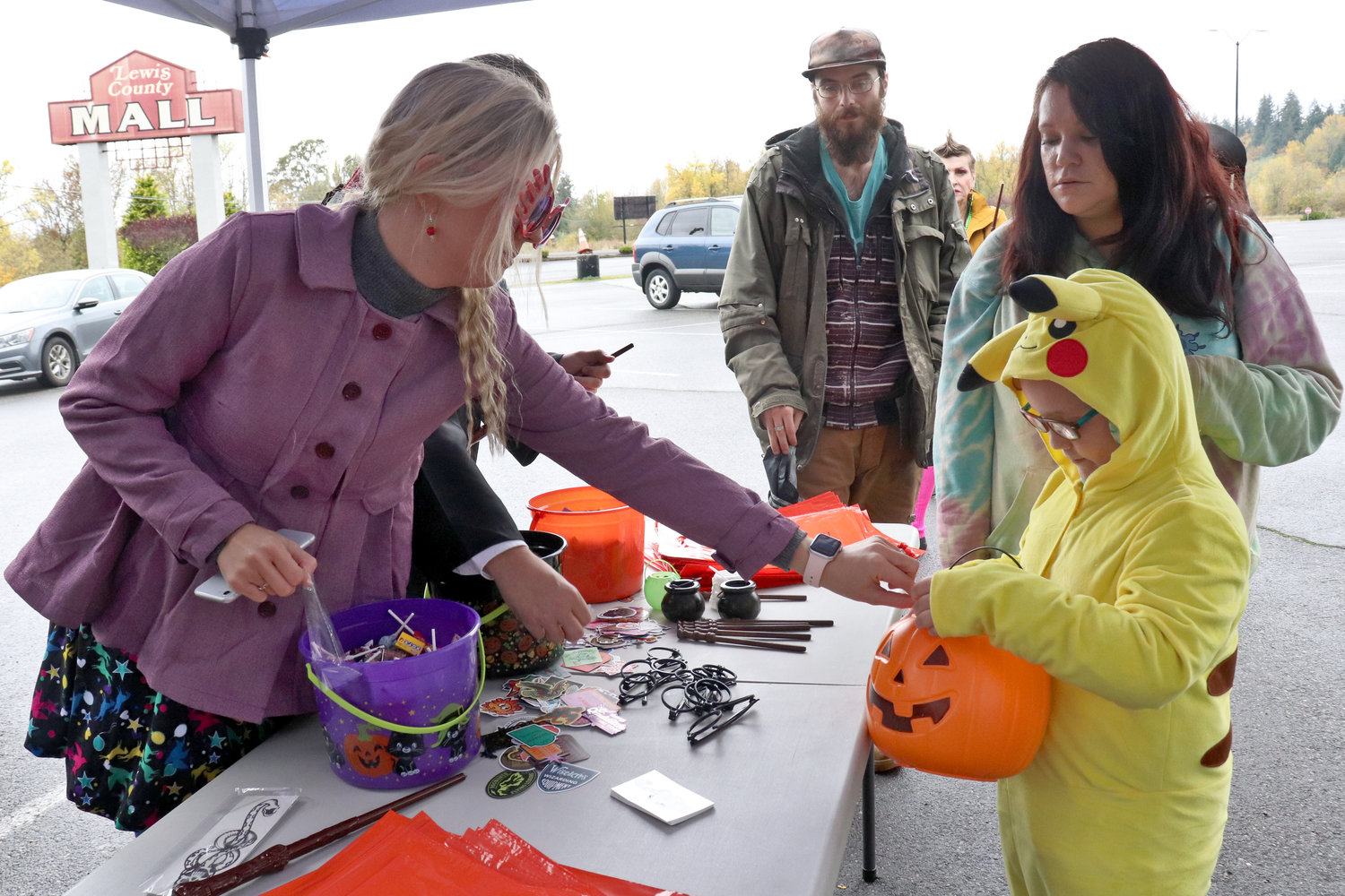 Twin Transit staff hand out candy and stickers to trick-or-treaters in the Trick or Treat Transit bus boarding area at the Lewis County Mall on Monday.
