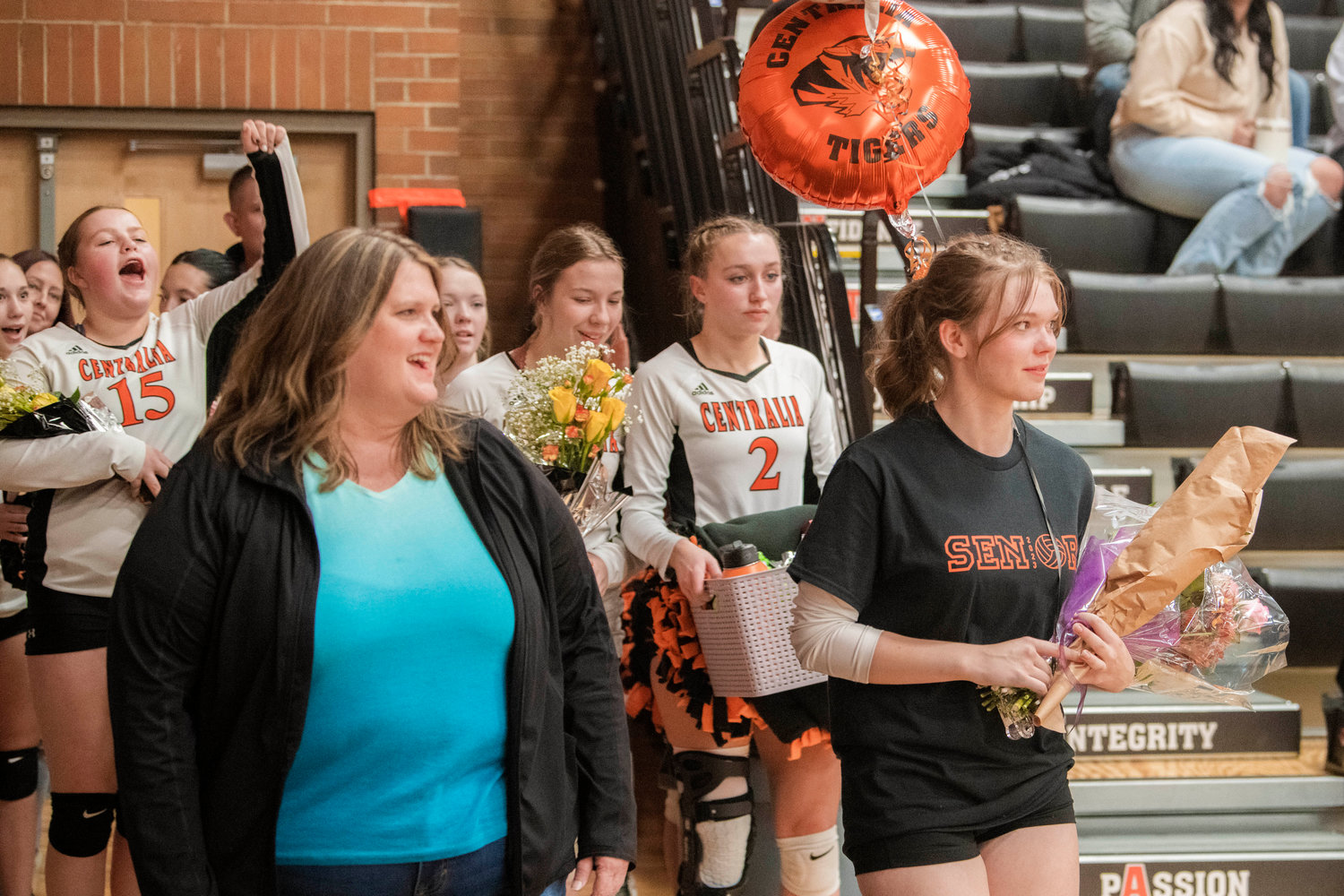 Athletes cheer as Maddie Buchanan is honored during senior night at Centralia High School.