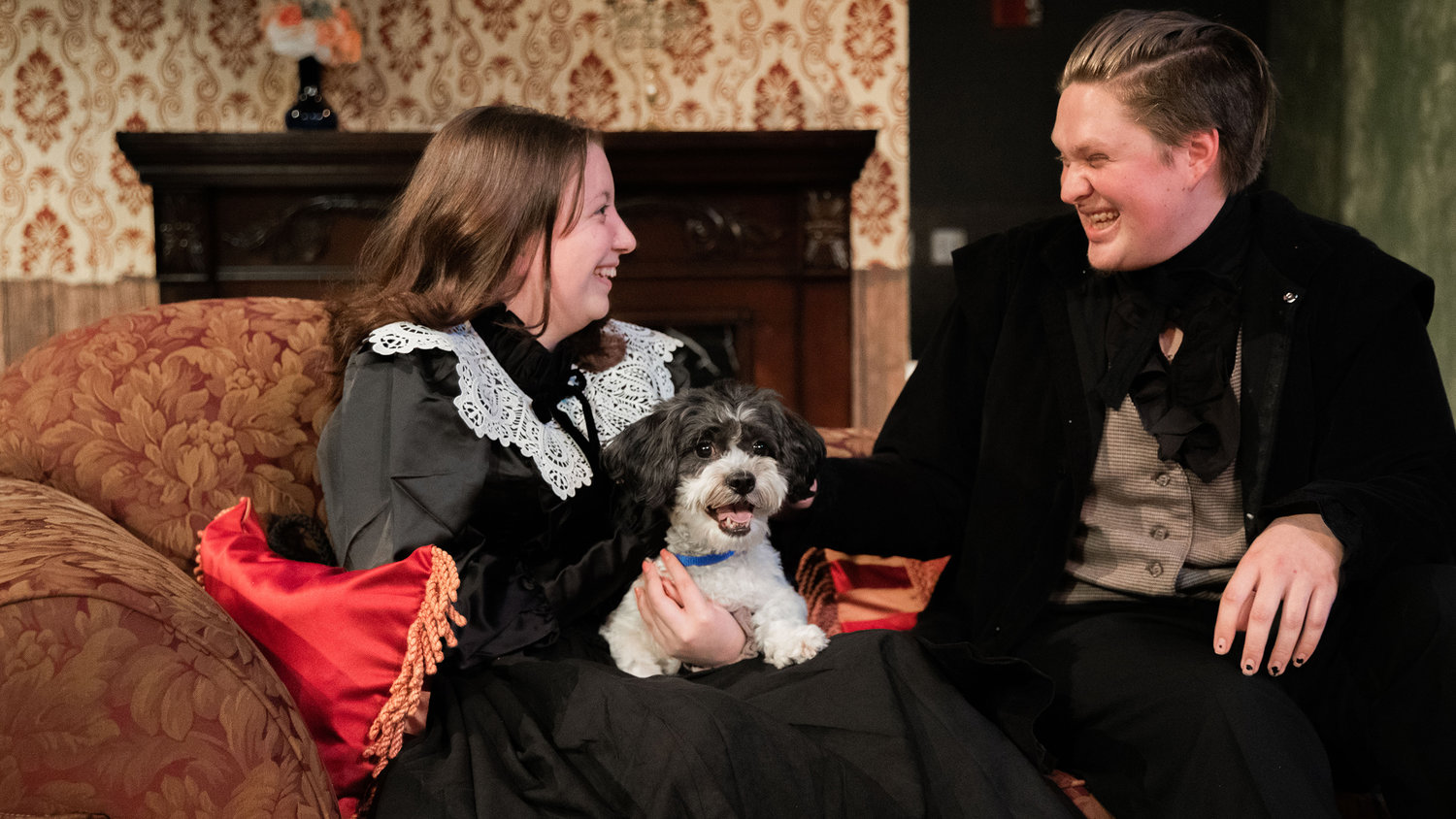 Alyssa Graves playing “Elizabeth Barrett,” and Derek Kealoha playing “Robert Browning,” smile while performing on stage with a dog named Ozzy playing “Flush,” during dress rehearsals for “Leaving 50 Wimpole Street,” a play by John Pratt directed by Emmy Kreilkamp presented by the Centralia College Theatre program.