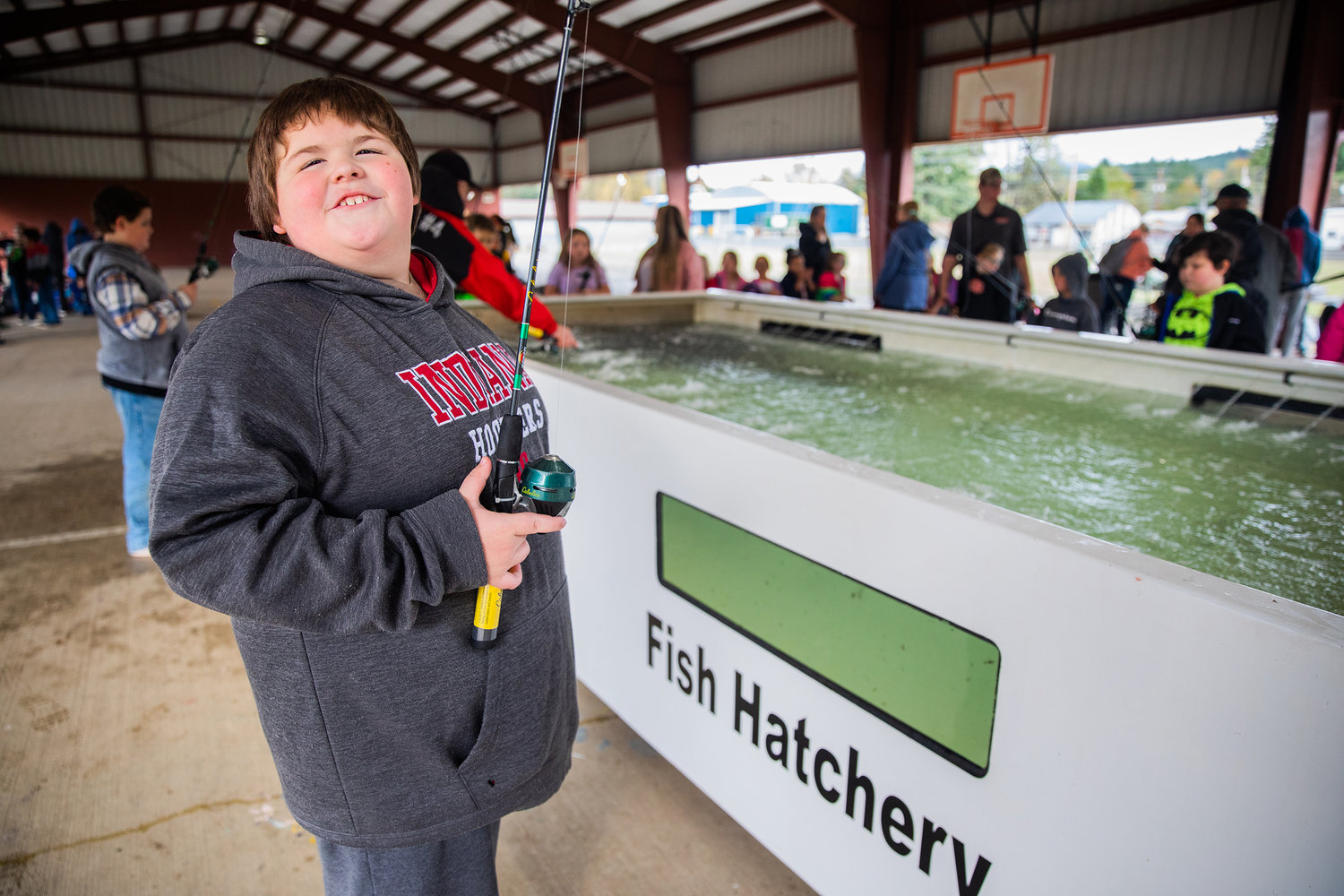 Abraham Kistennacher, a fourth grade student at Morton Elementary, smiles while talking about his experience fishing Monday afternoon as a trout hatchery visits the school for a learning opportunity.