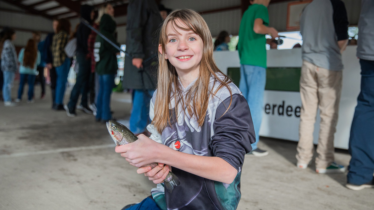 Payton Neumeyer, a sixth grade student at Morton Elementary, smiles for a photo with a trout caught Monday afternoon.
