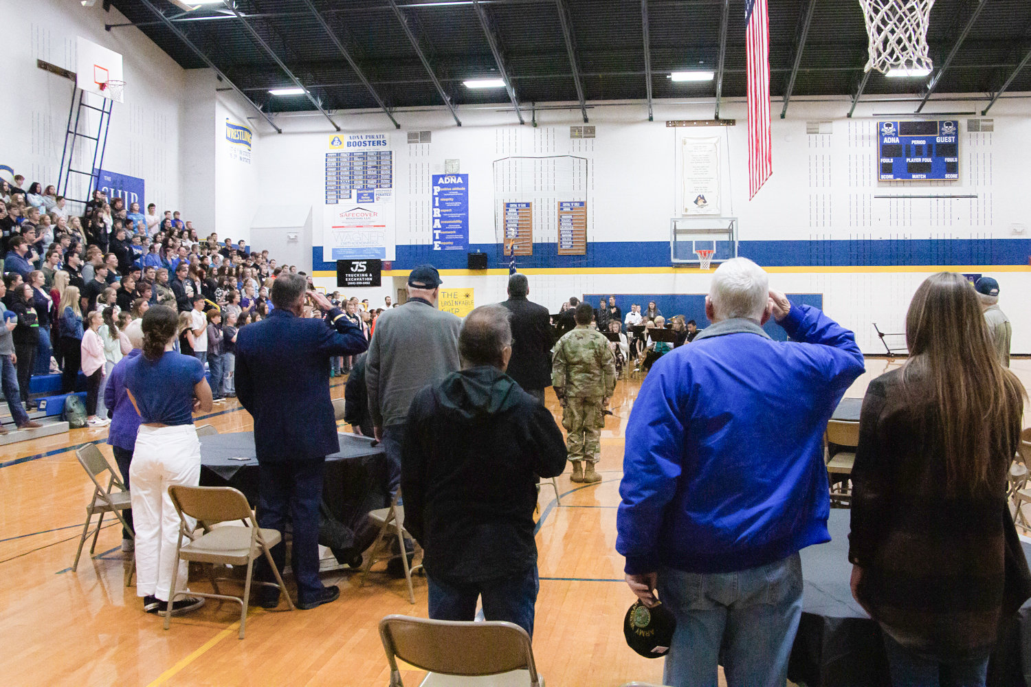 Veterans who had been invited to be honored stand for the national athem at Adna High School's Veterans Day assembly Tuesday Morning.