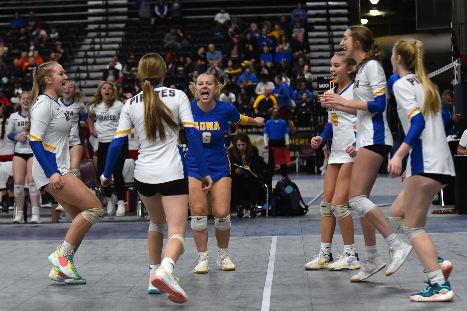 The Adna volleyball team celebrates a point during the first set of its three-set win over No. 12 Tri-Cities Prep in the first round of the 2B state volleyball tournament on Nov. 10, at the Yakima Valley SunDome.