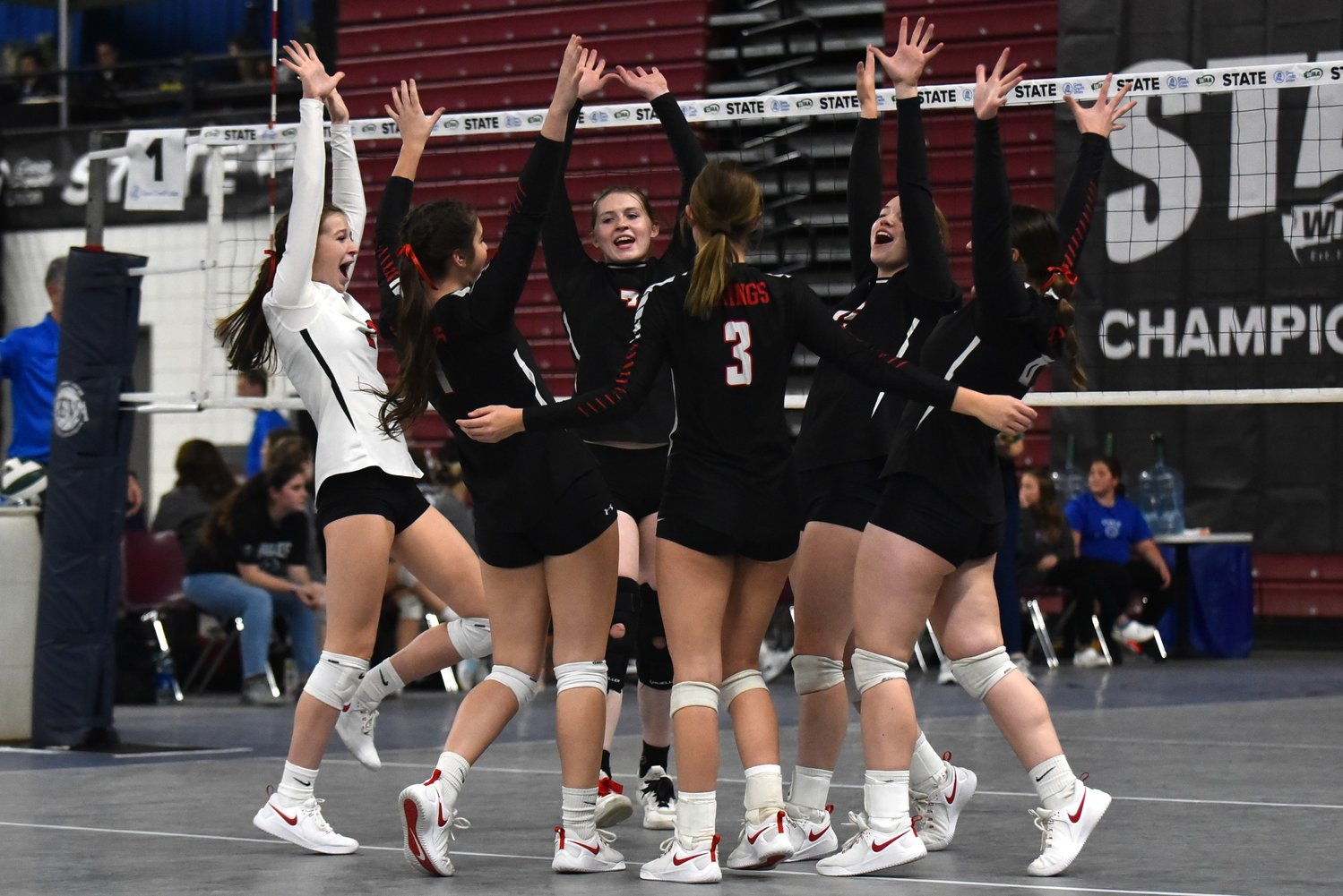 The Mossyrock volleyball team celebrates a point during the first set of its first-round sweep of Grace Academy at the 1B state volleyball tournament, Nov. 10 in Yakima.