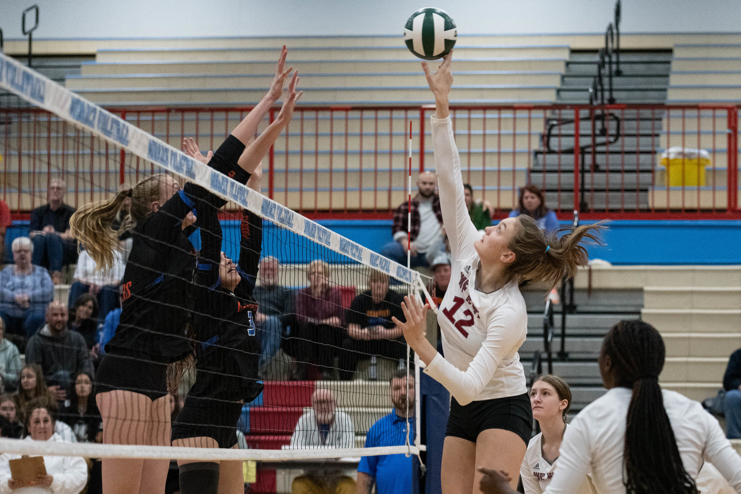 W.F. West middle Julia Dalan tips a ball over the net against Ridgefield in the first round of the 2A District 4 tournament at Mark Morris Nov. 10.