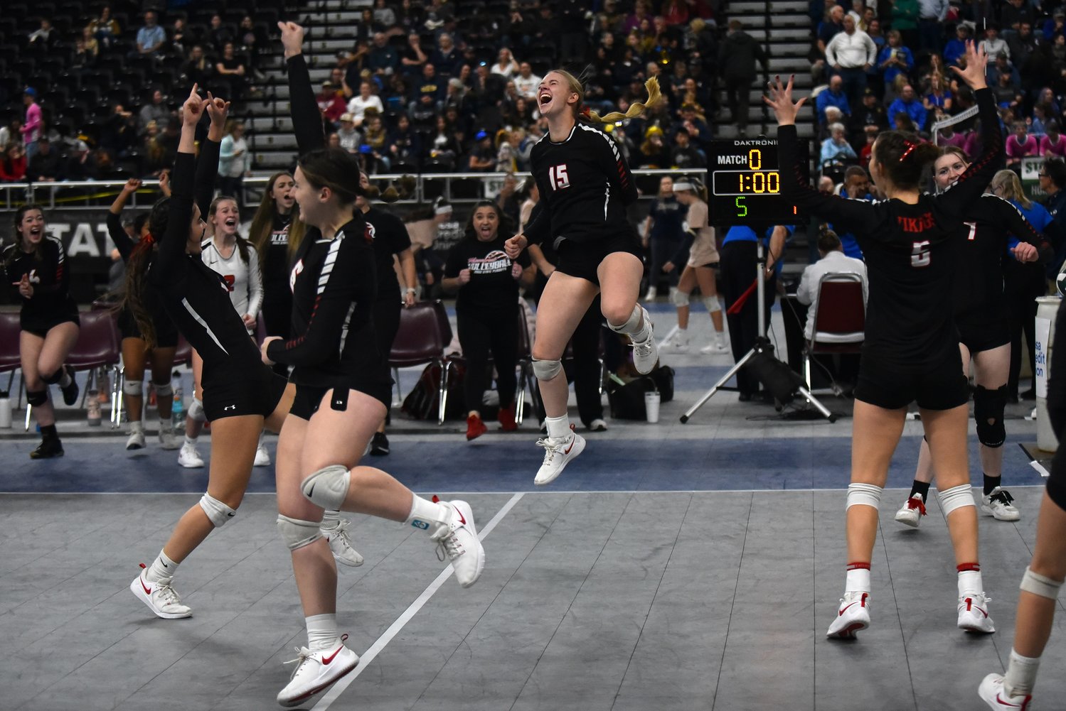 Hailey Brooks (15) and the Mossyrock volleyball team celebrates a point in its three-set win over Mary Walker in the 1B state semifinals on Nov. 11 in Yakima.