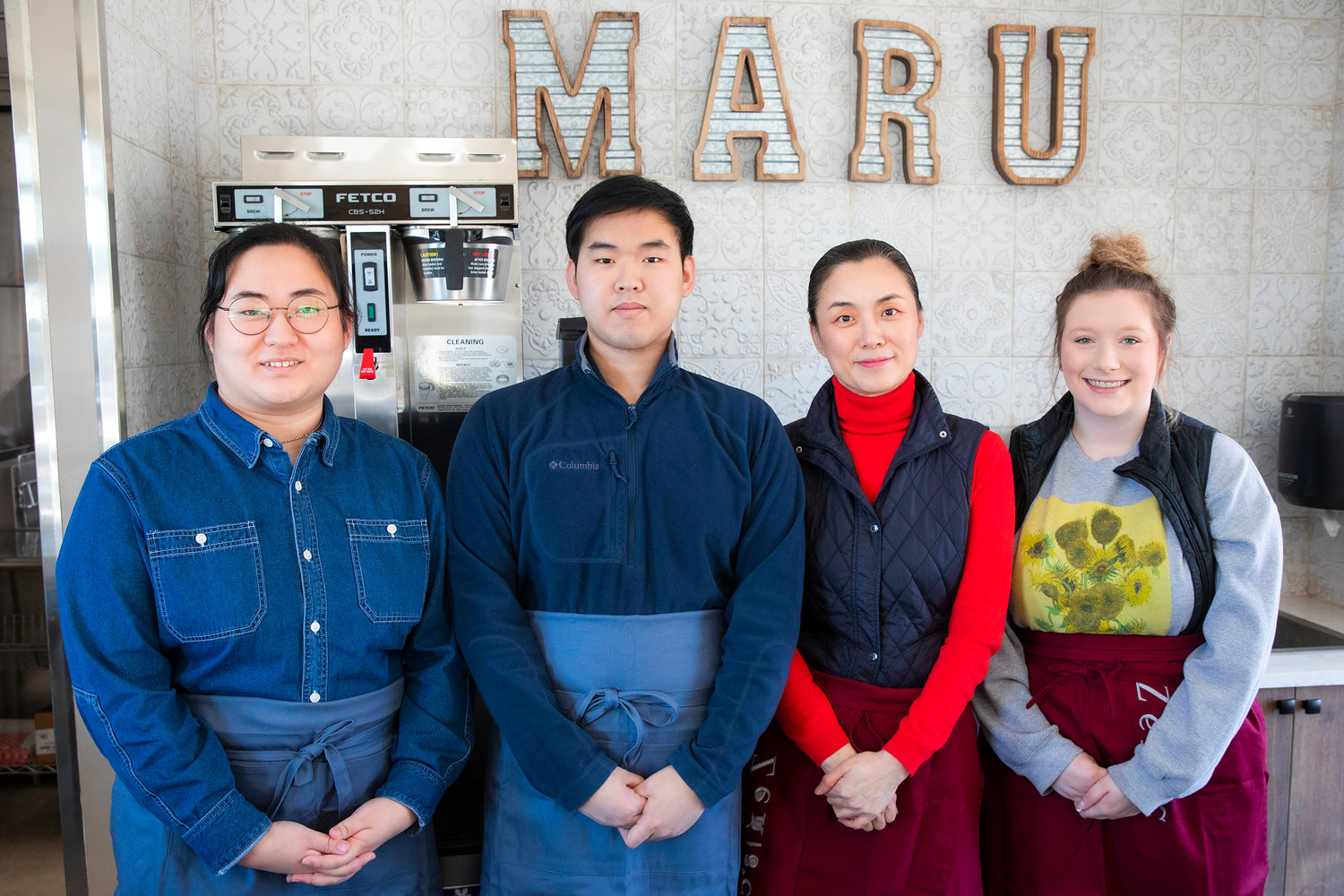 From left, Sage, Chan and Jenny Lee pose for a photo alongside barista Emily Combs Monday afternoon at Cafe Maru & Deli in Chehalis.