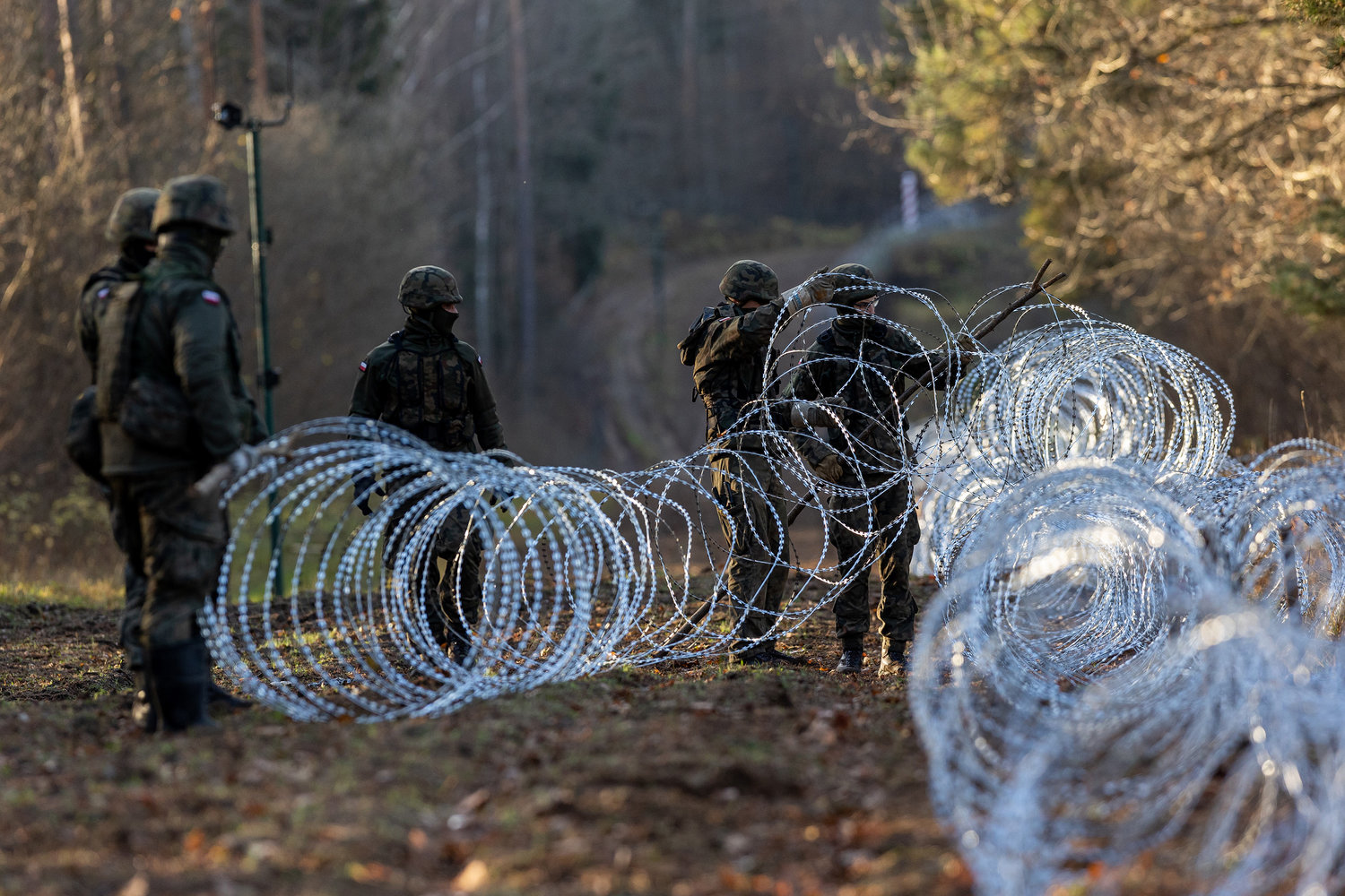 Polish army soldiers installing concertina wire at Poland's border with Russian exclave Kaliningrad on Monday, Nov. 14, 2022, in Goldap, Poland. The project comes after Moscow's aviation authority started to launch flights from the Middle East and North Africa to Kaliningrad, according to Poland's Defense Minister Mariusz Blaszczak. (Paulius Peleckis/Getty Images/TNS)