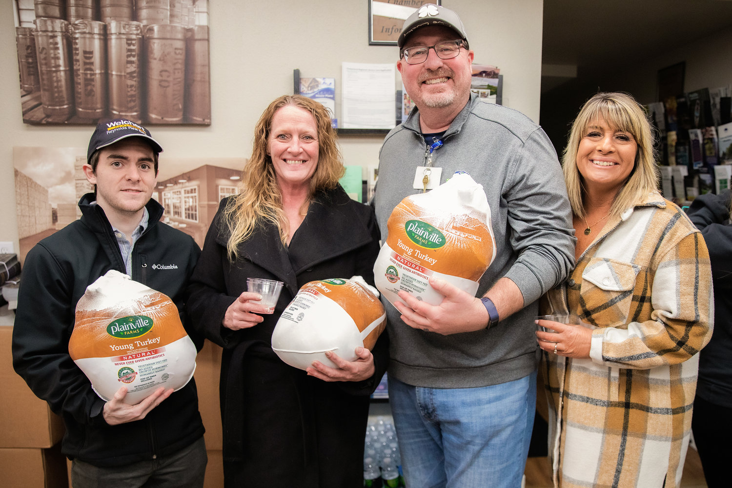 From left, Jake Stepp, Christy Ward, Chris Thomas and Lindy Waring pose for a photo after winning frozen turkeys during a Business After Hours event at the Centralia-Chehalis Chamber of Commerce building.