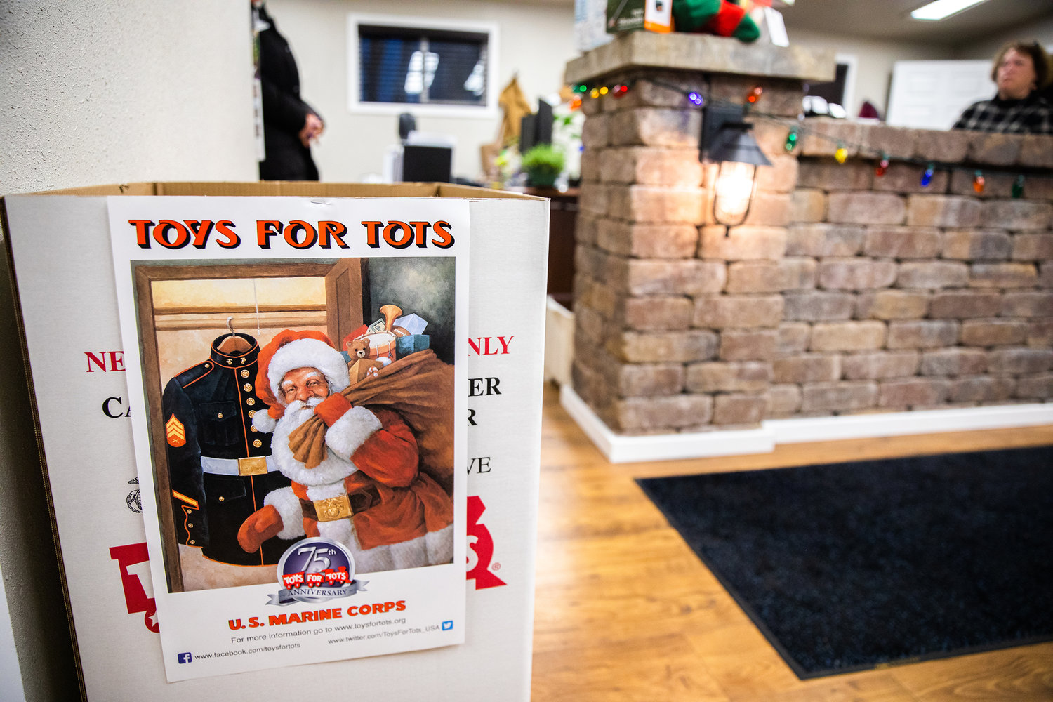 A Toys For Tots collection bin sits on display during a Business After Hours event at the Centralia-Chehalis Chamber of Commerce building.