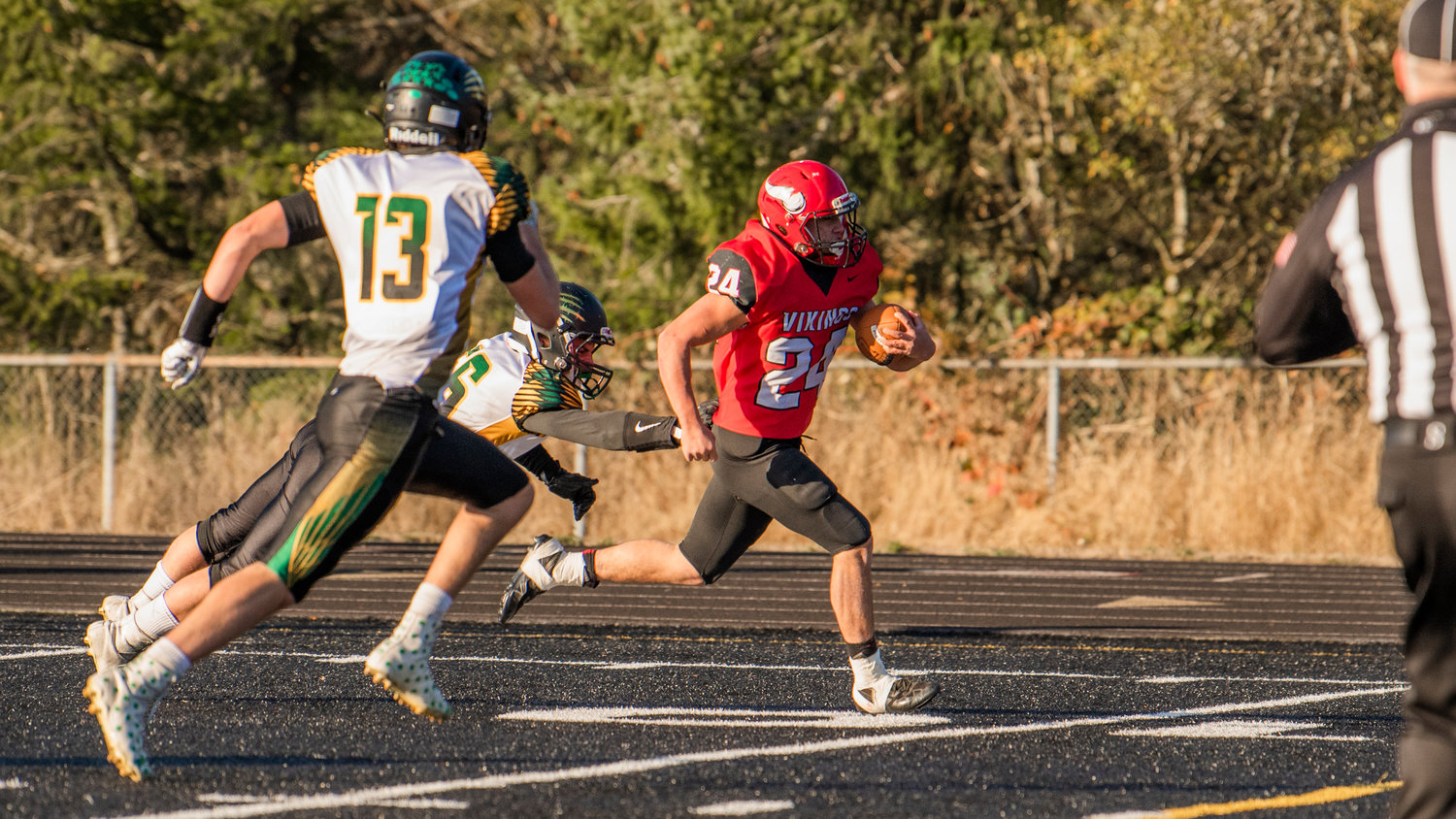 Mossyrock senior Sage Greisen (24) runs past Liberty Bell defenders to score during a Saturday afternoon game in Tenino.