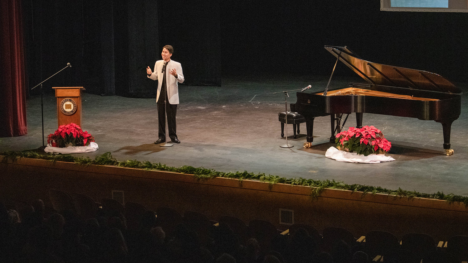Charlie Albright smiles on stage inside the Corbet Theatre Friday evening during a “Classical Christmas Fundraiser Concert,” with proceeds going to the Charlie Albright Scholarship at Centralia College.