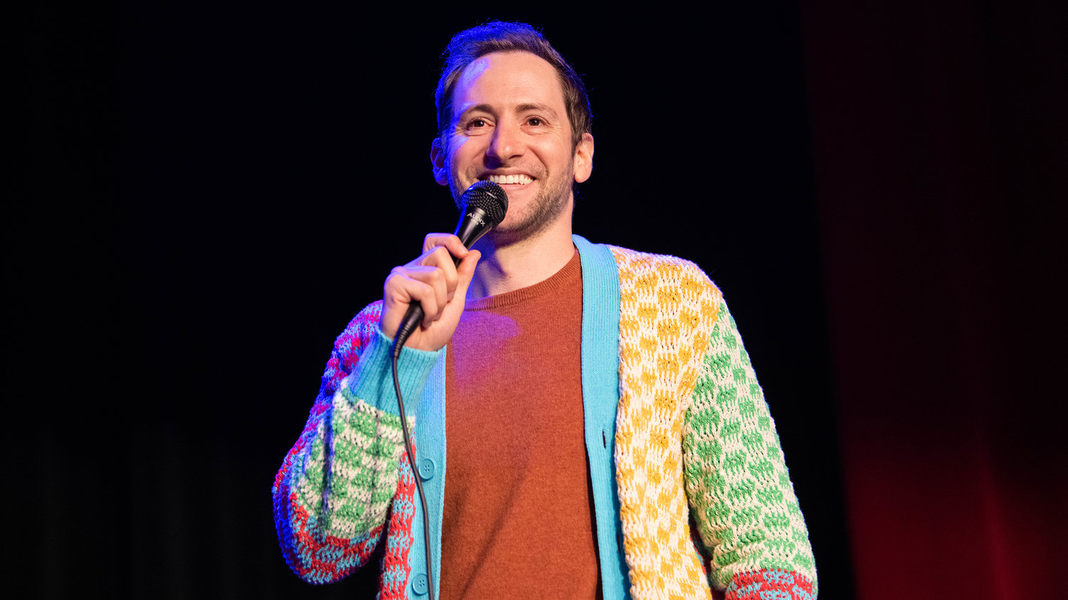 Samuel J. Comroe smiles while performing a sold out comedy show Friday night at the McFiler’s Chehalis Theater during his “Come Get These Giggles,” tour across the United States.