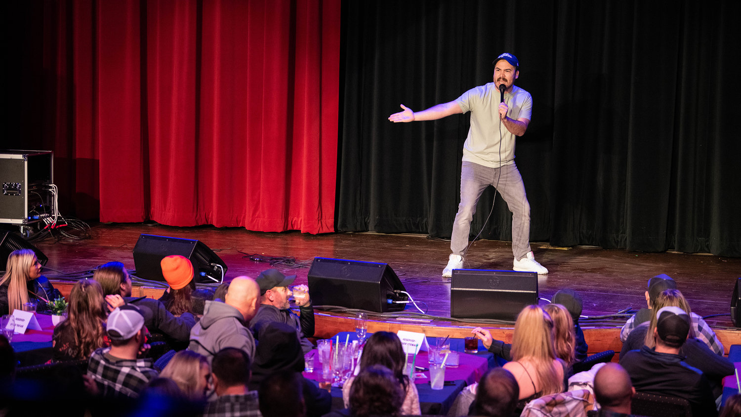 Ralph Guerra gestures toward the crowd while performing a sold out comedy show Friday night at the McFiler’s Chehalis Theater.