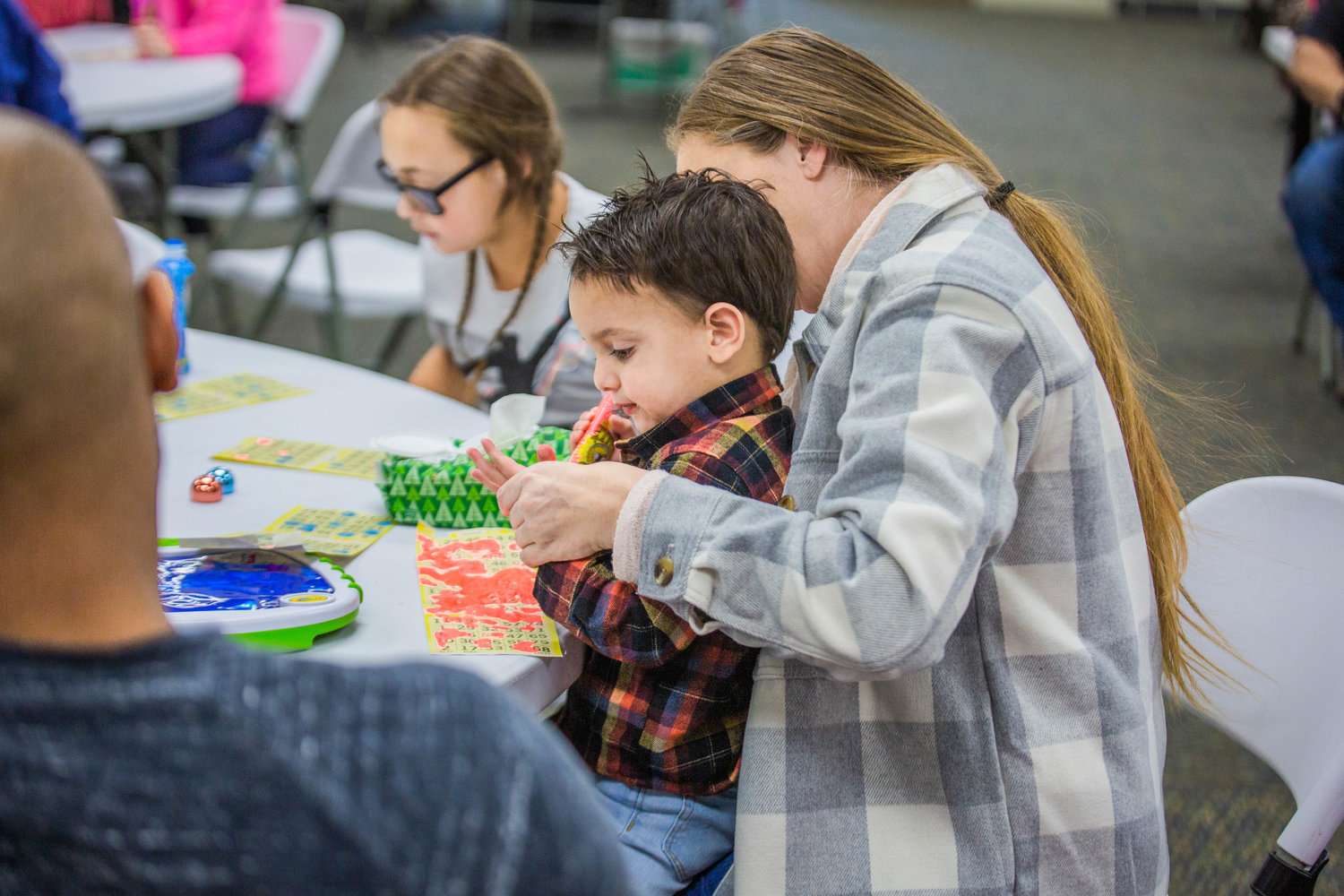 Wesley Ferrell, 2, gets bingo ink on his fingers during the Twin Cities Rotary Club Turkey Bingo in the Chehalis Eagles building on Saturday afternoon.