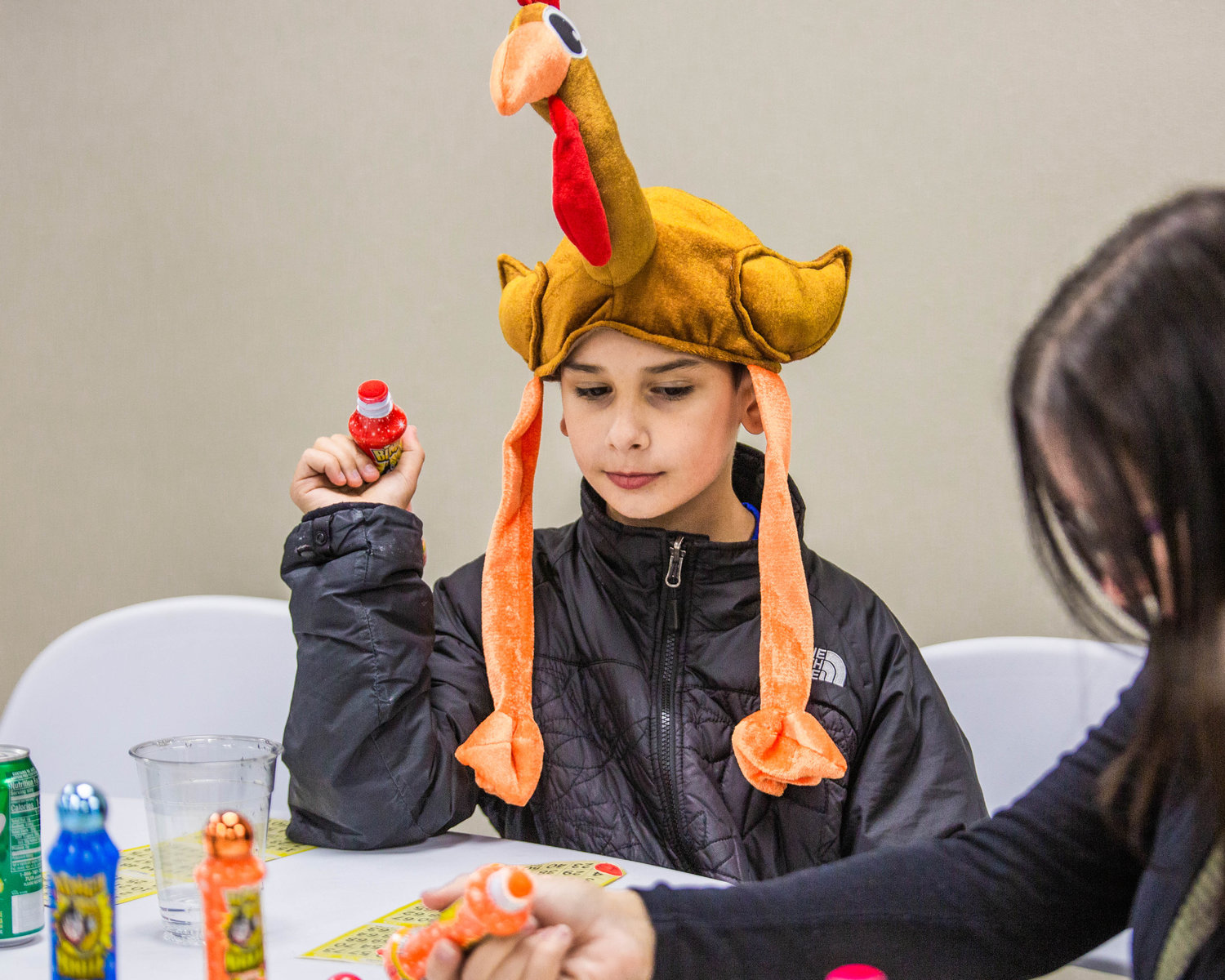 Antonio Abbarno, 9, of Centralia, sports a turkey hat during Twin Cities Rotary Club Turkey Bingo in the Chehalis Eagles building on Saturday afternoon.