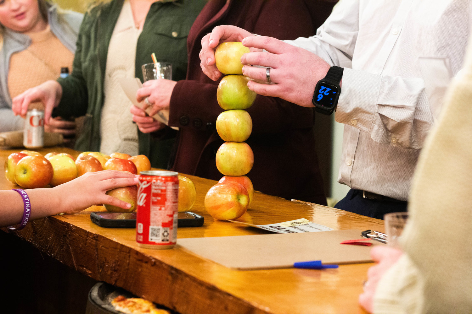 Participants stack apples at City Farm Chehalis during a Harmonies for Hope event raising money for the Boys and Girls Club of Lewis County Saturday night.