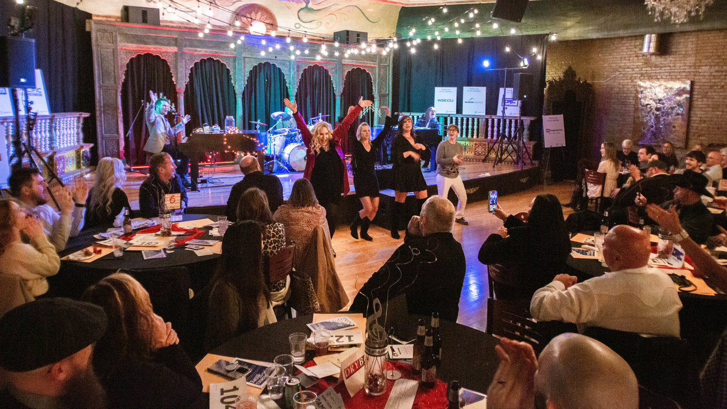Attendees dance to dueling pianos during a Harmonies for Hope event raising money for the Boys and Girls Club of Lewis County Saturday night.