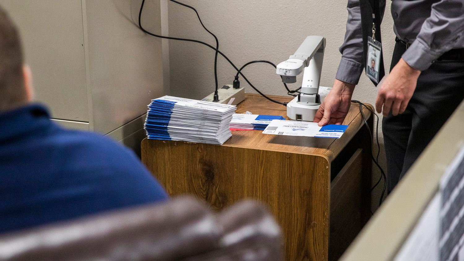 Elections Supervisor Terry Jouper reviews ballots with members of the Canvasing Board looking for incorrect postage dates during a Wednesday morning meeting at the Lewis County Courthouse in Chehalis.