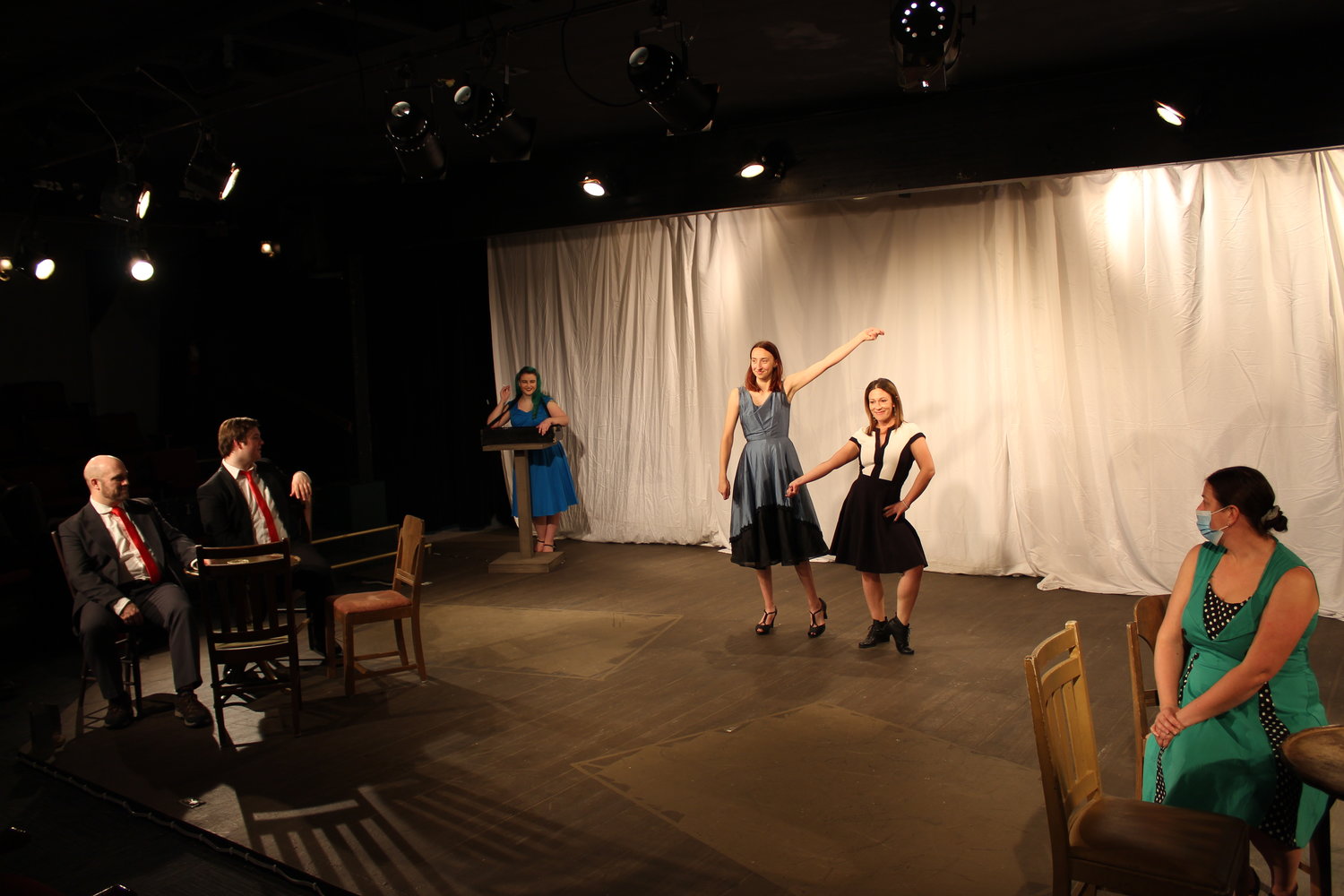 Singing duo Bob, portrayed by Noah McKenzieSullivan, and Phil, portrayed by Sean-Patrick McNeal, catch a show by singing sister duo Betty, portrayed by Melyssa Johnson, and Judy, portrayed by Lizzie Conner. Also pictured is cigarette girl, portrayed by Brittany Wilcox, and Rhoda, portrayed by Nicole Gal