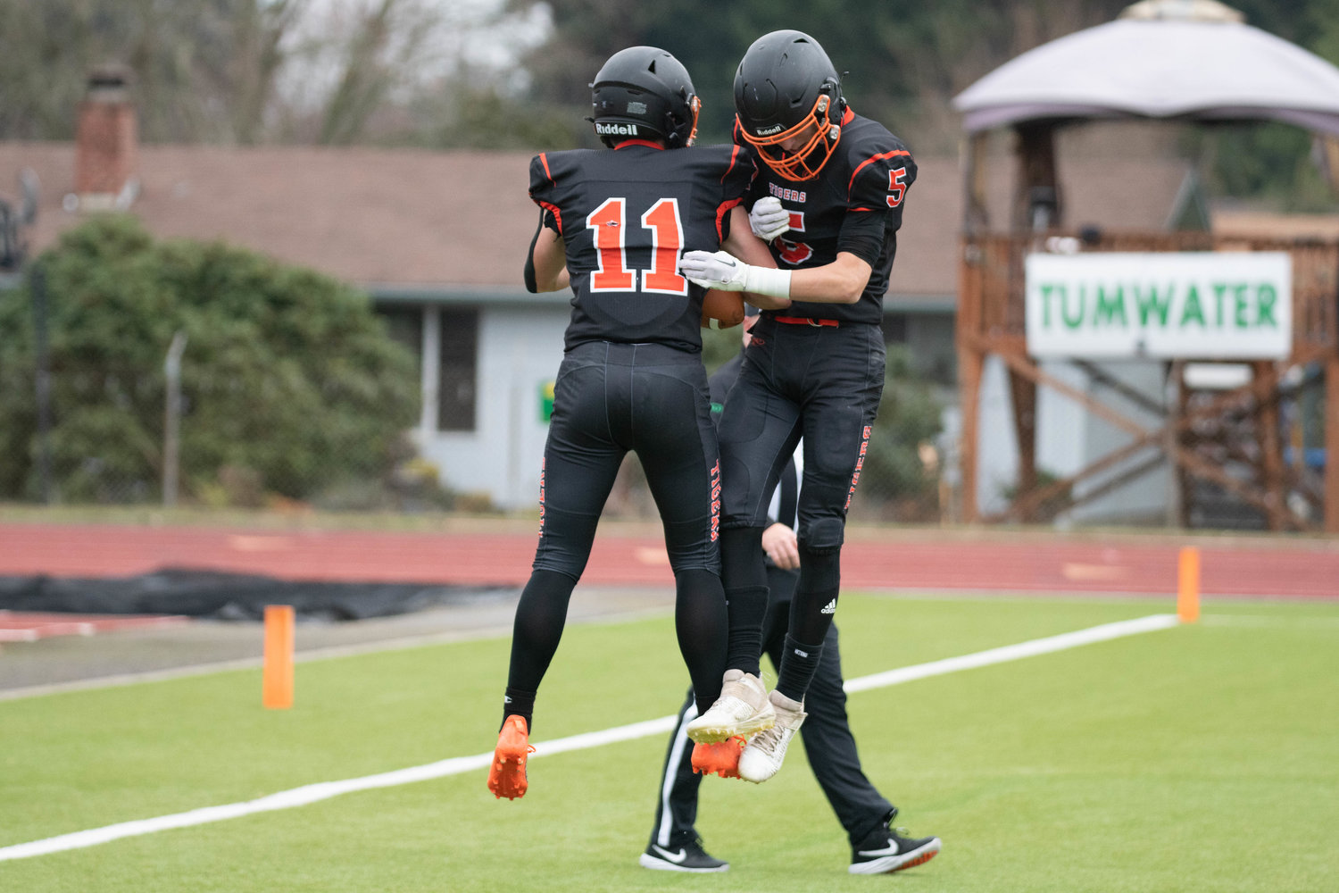 Colin Shields (11) celebrates a first-quarter touchdown with Karsen Denault (5) during Napavine's 49-6 semifinal win over Chewelah on Nov. 26 in Tumwater.