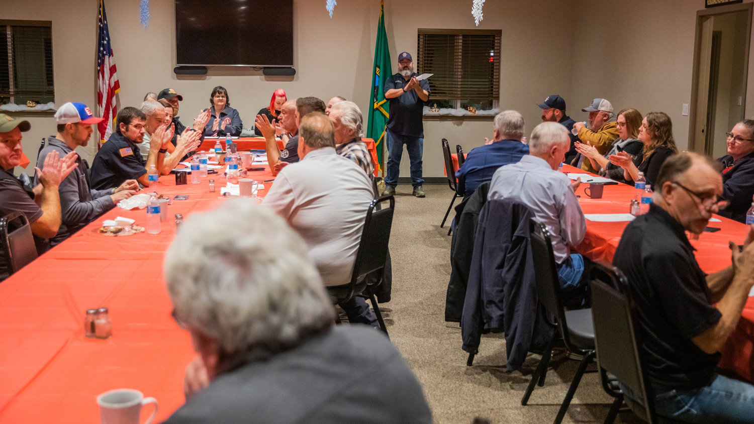 Attendees at a meeting thank visitors from Uncle Jim’s Smokehouse for a dinner served Monday night at the Lewis County Fire District 3 building in Mossyrock.