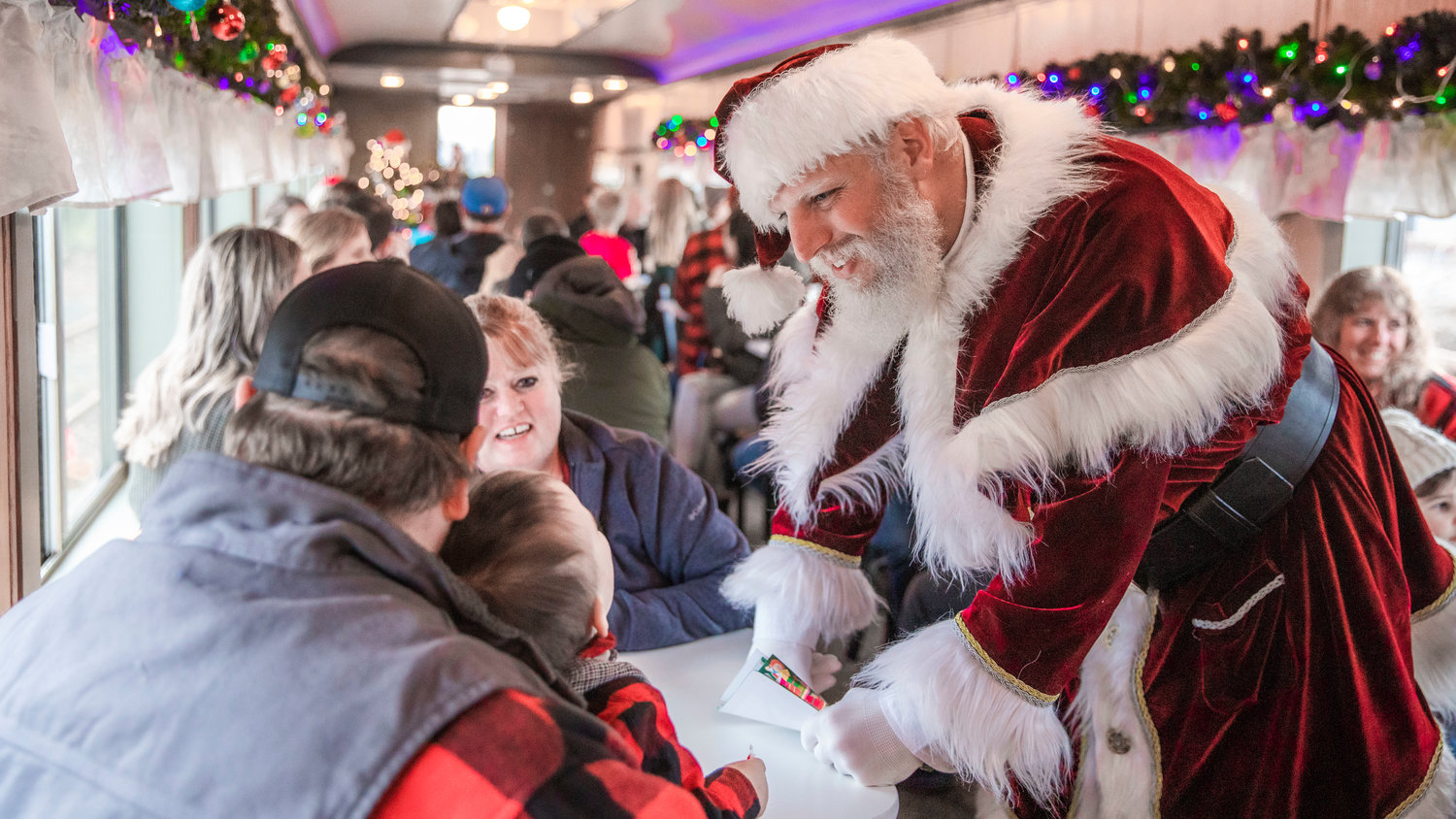 Santa visits with passengers at the Chehalis-Centralia Railroad Depot Museum on Saturday as a lack of insurance continues to halt transportation services.