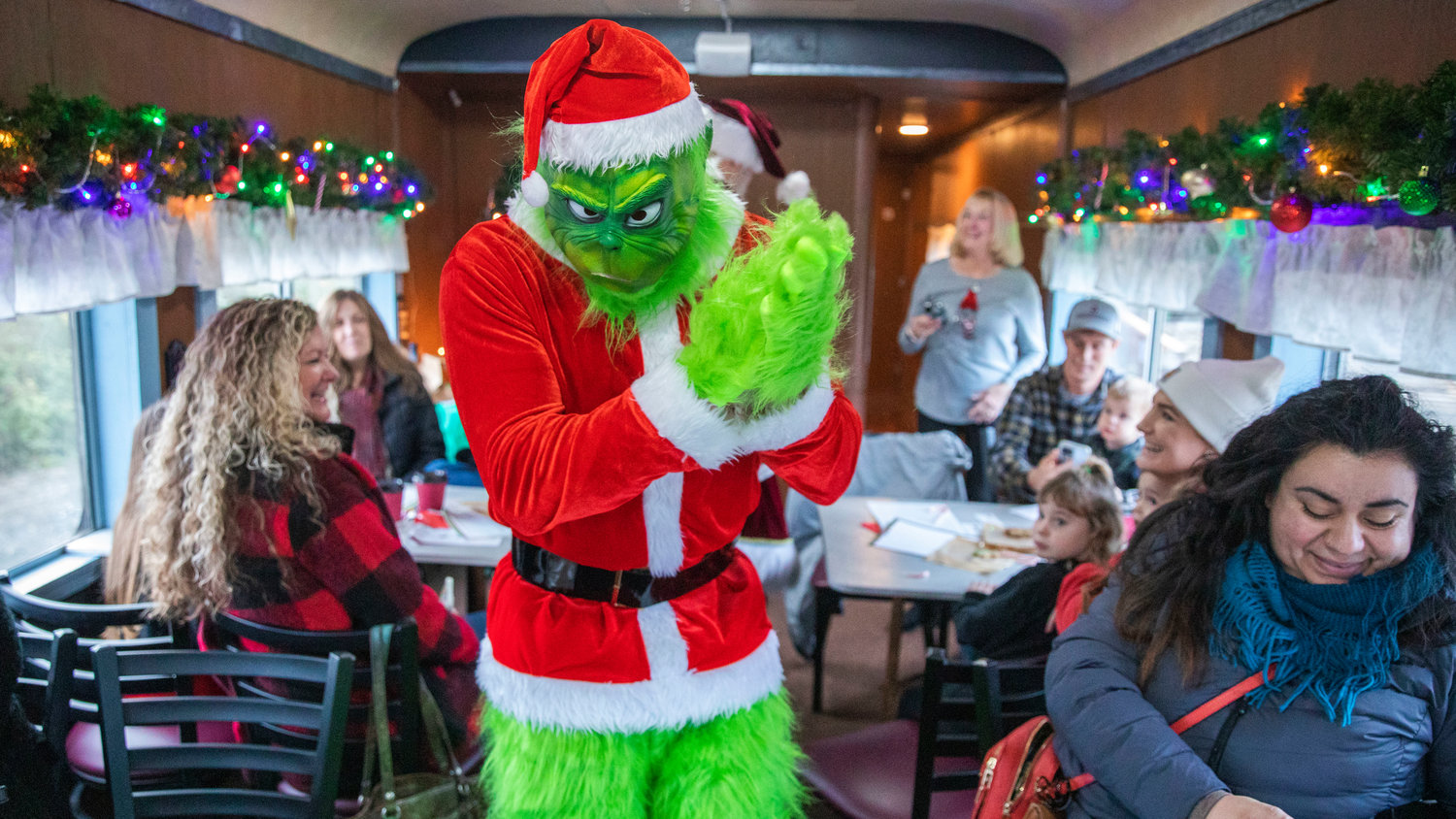 The Grinch makes an appearance at the Steam Train Depot in Chehalis on Saturday as a lack of insurance continues to halt transportation services.